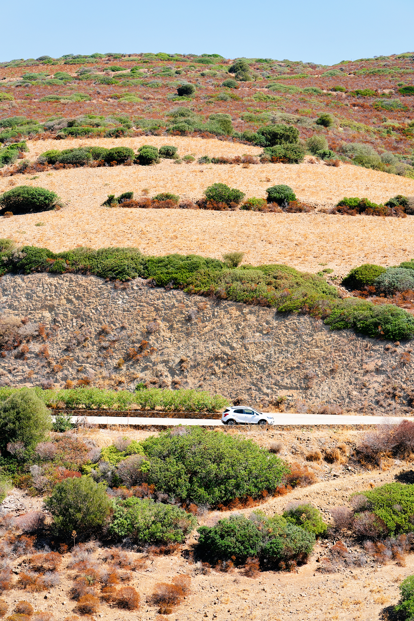 car in road in costa smeralda in sardinia island hills