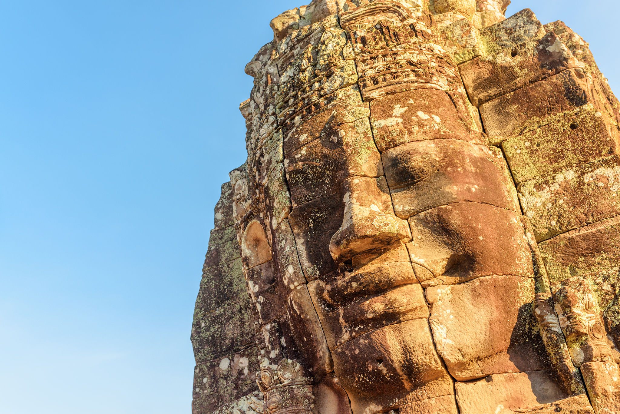 amazing view of giant stone face of bayon temple, angkor