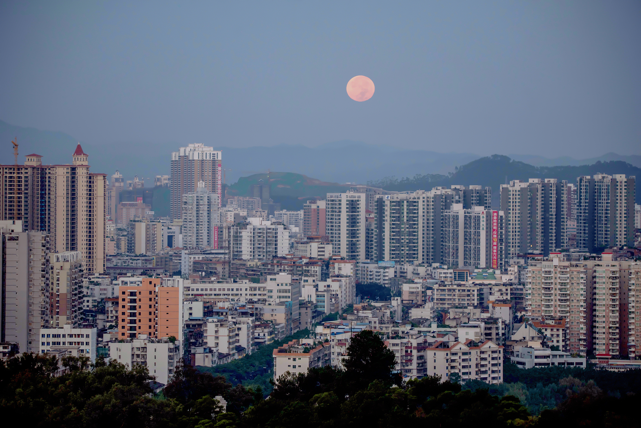广西梧州:早晨都市上空圆圆的月亮