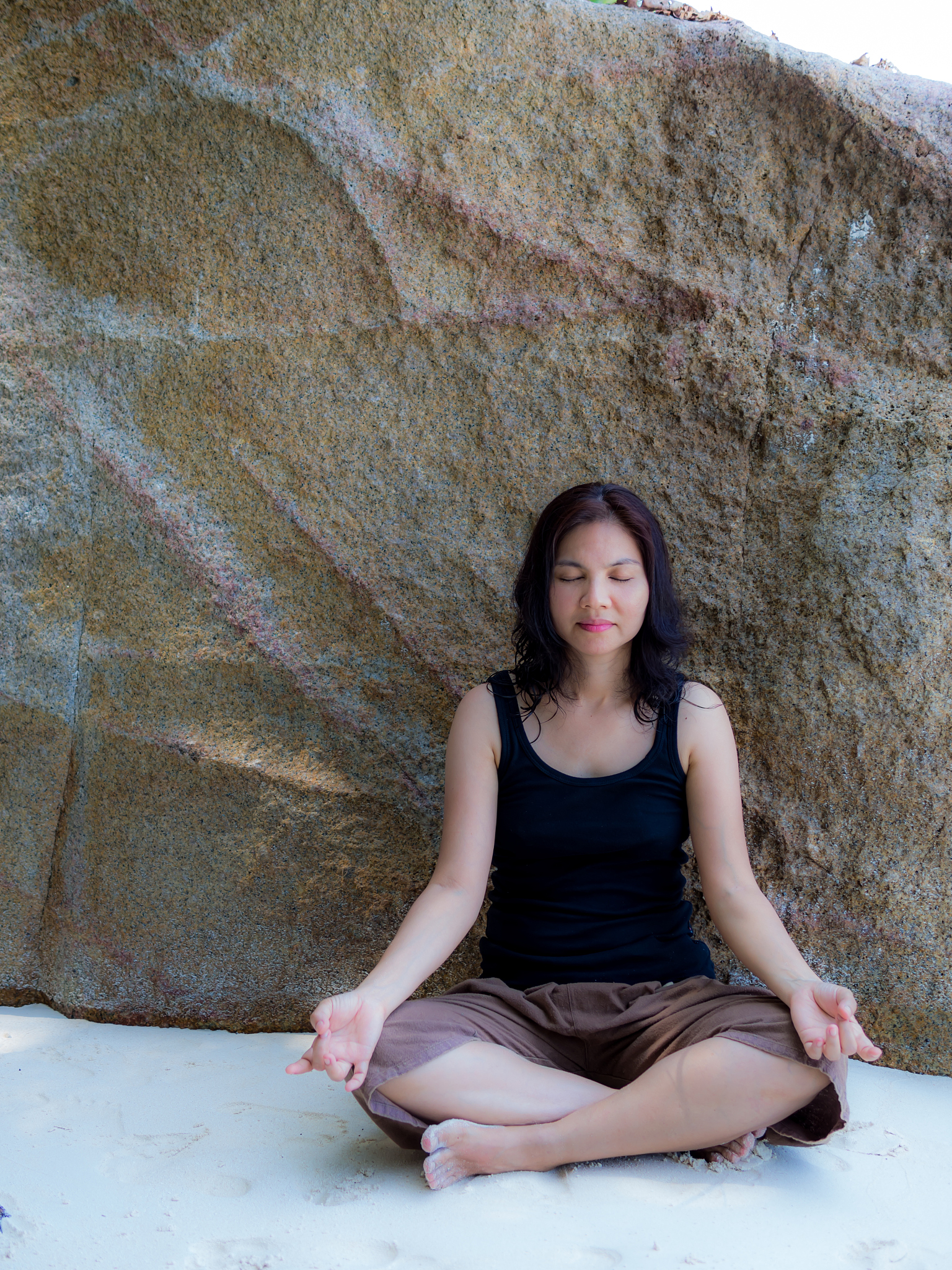 asain woman training yoga and meditation at the beach