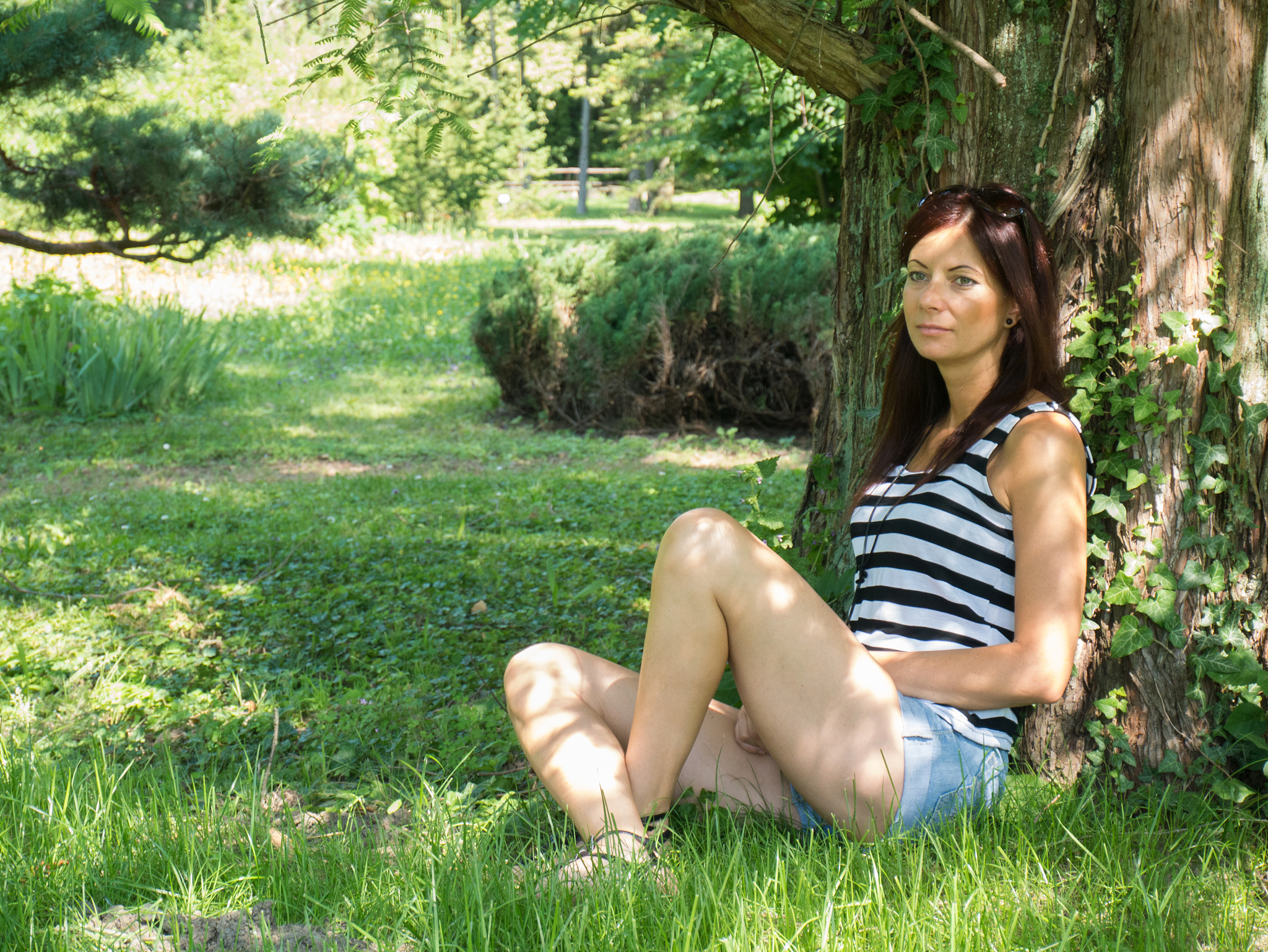 young woman sitting on a tree