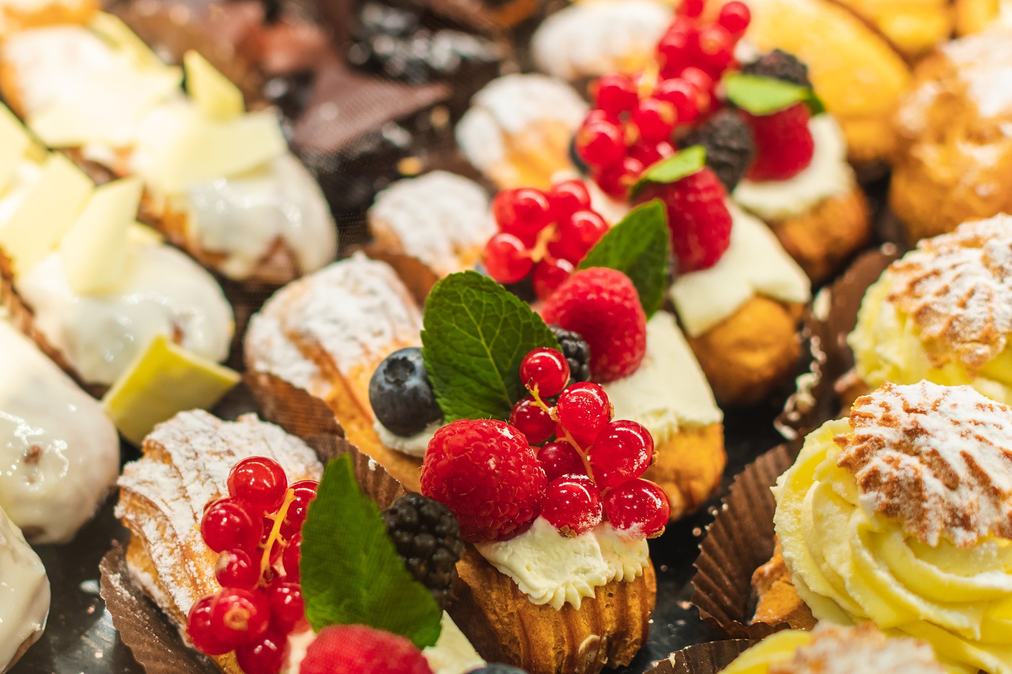 pastry shop with variety of donuts, muffins, creme brulee, cakes