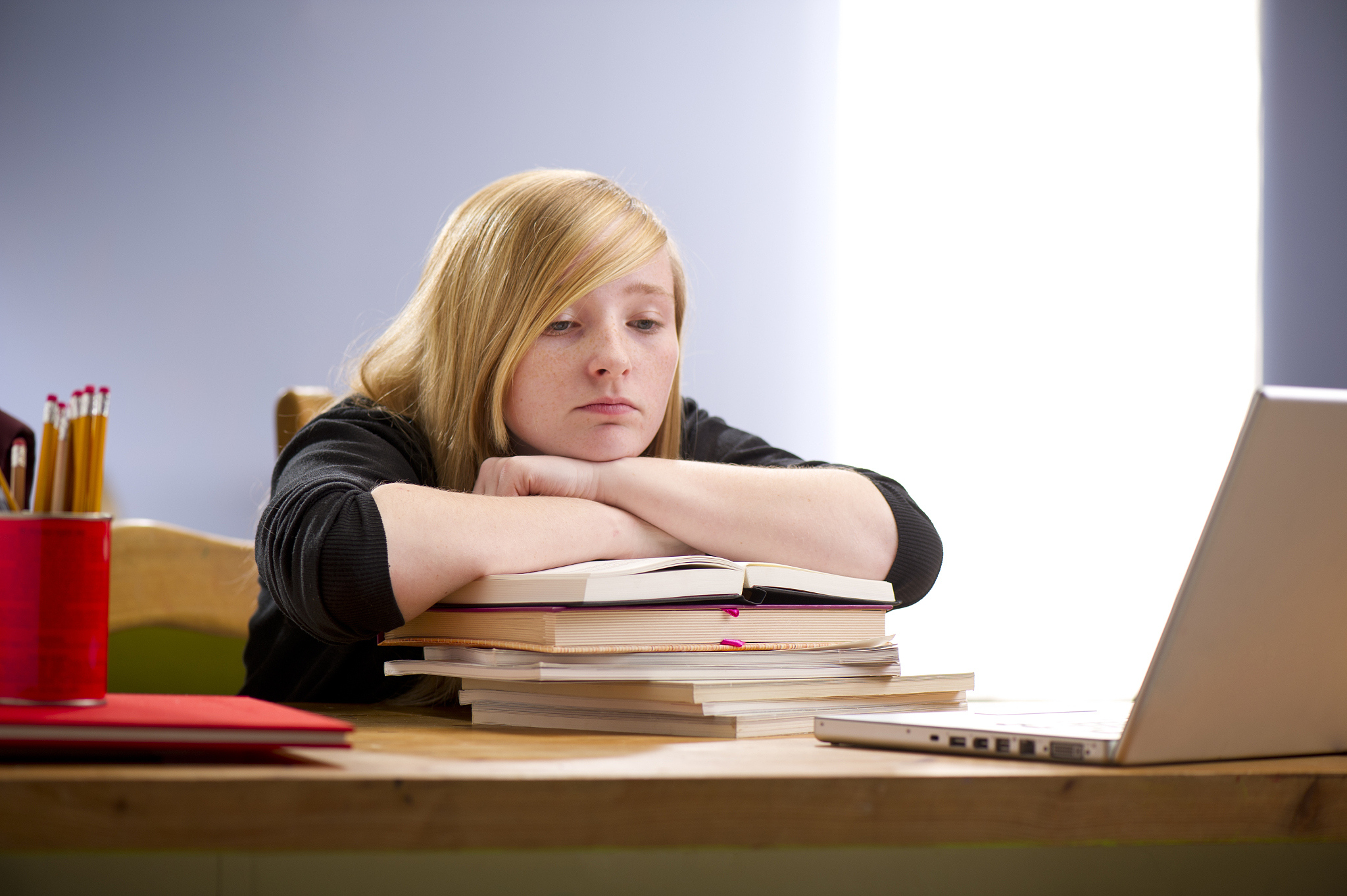 young teen bored of homework