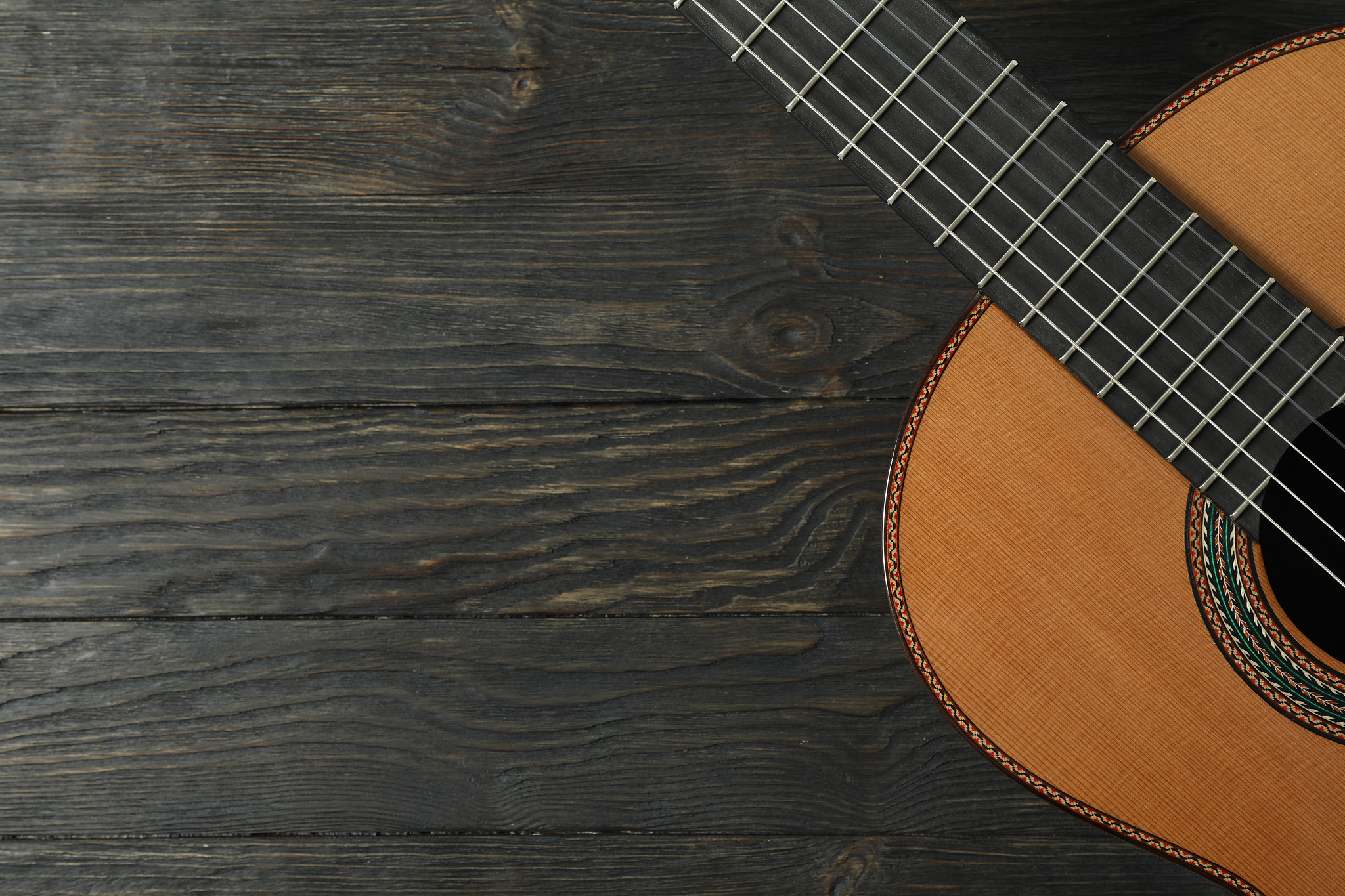beautiful six - string classic guitar on wooden background, spac
