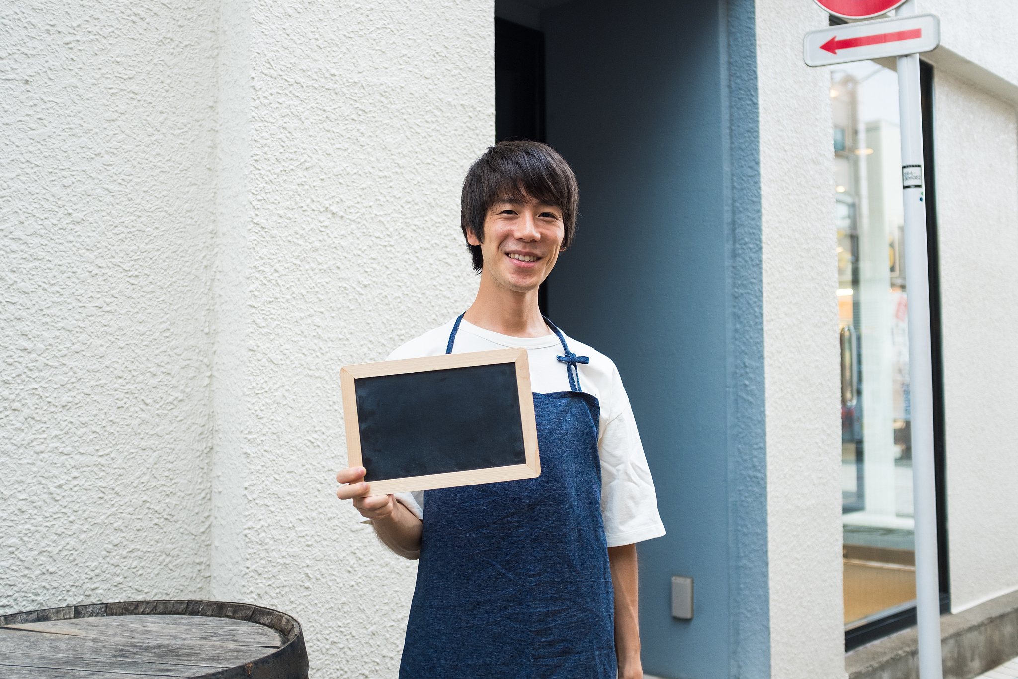man holding black board