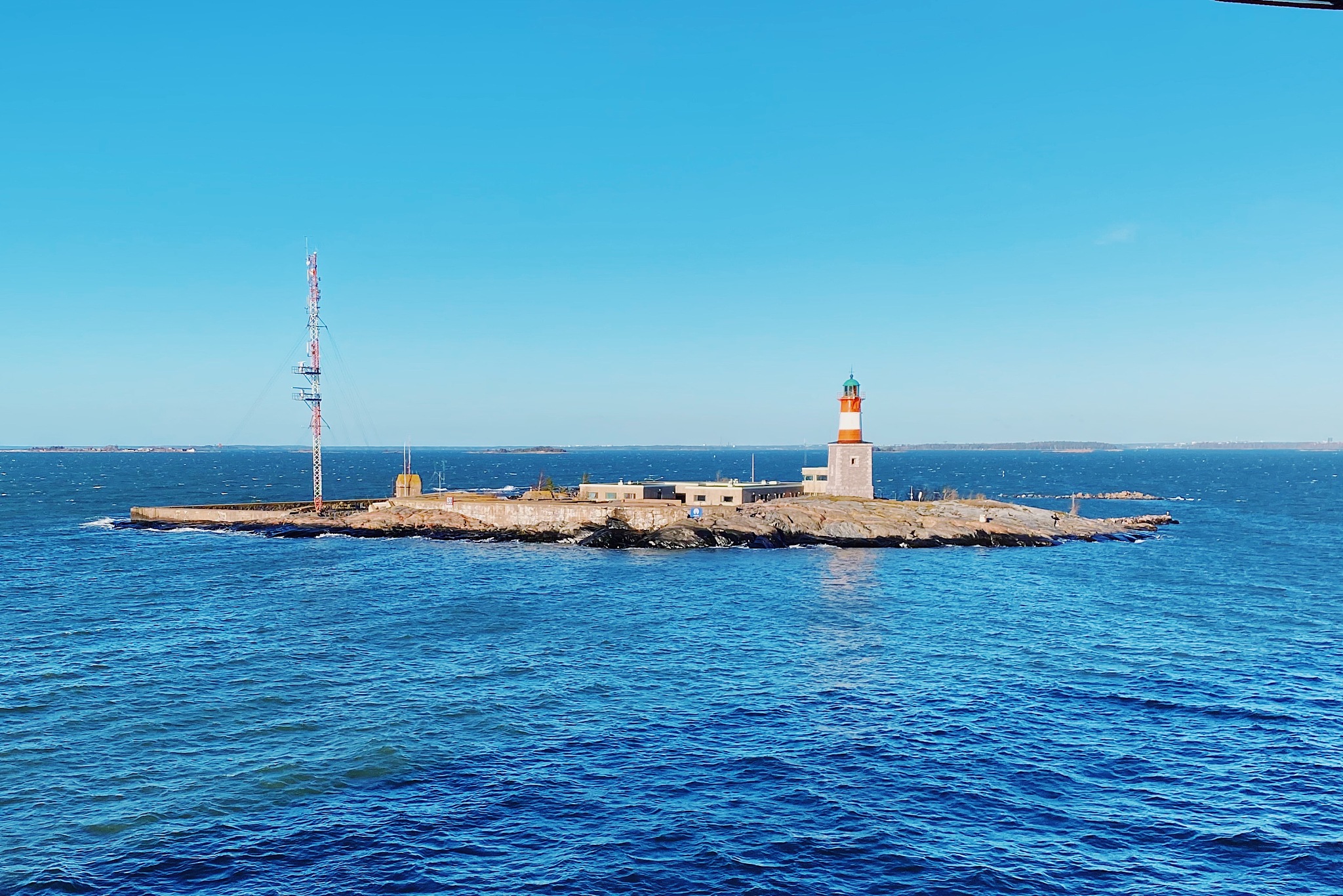 lighthouse by sea against sky
