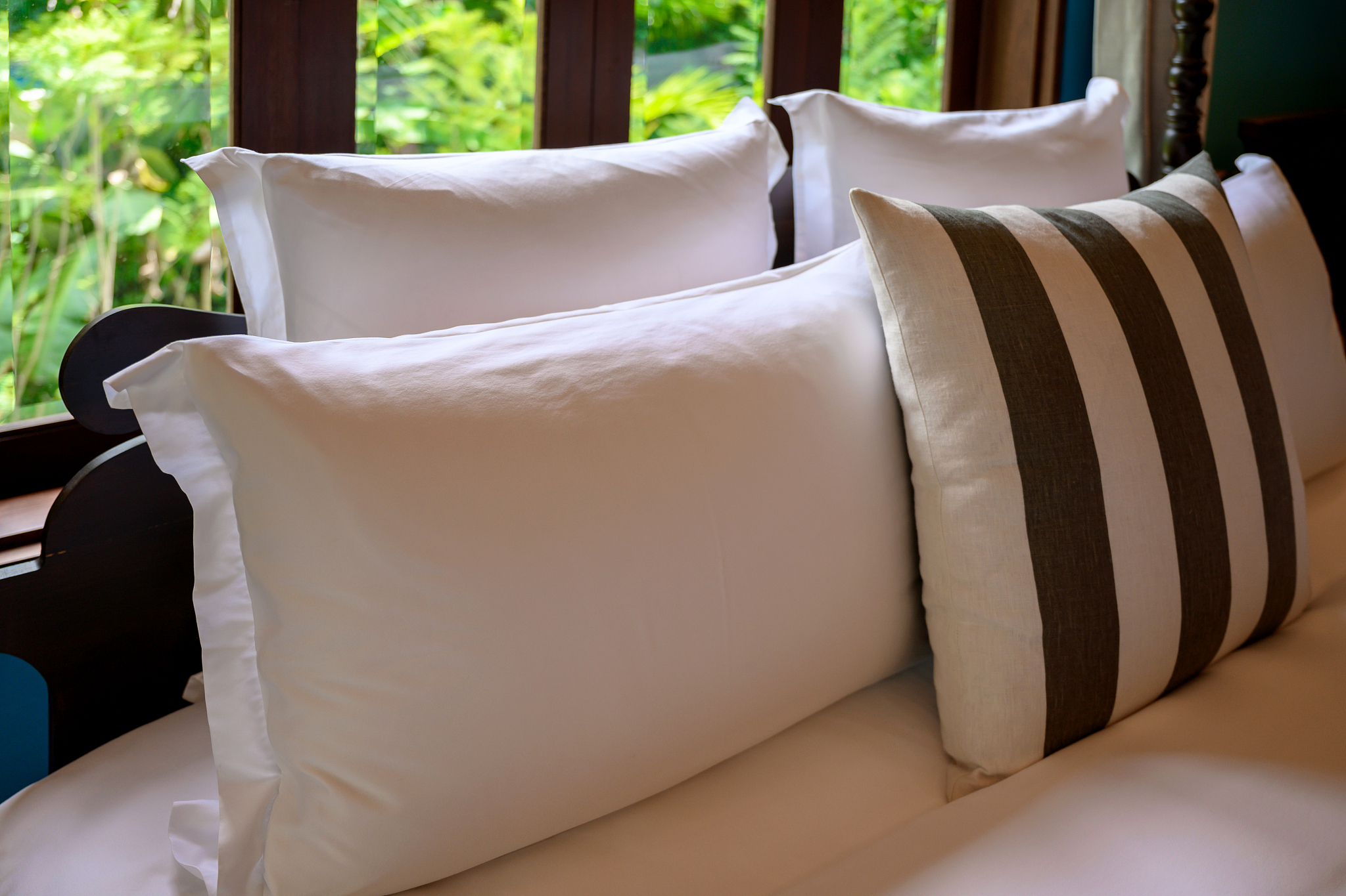 arranged pillows on bed