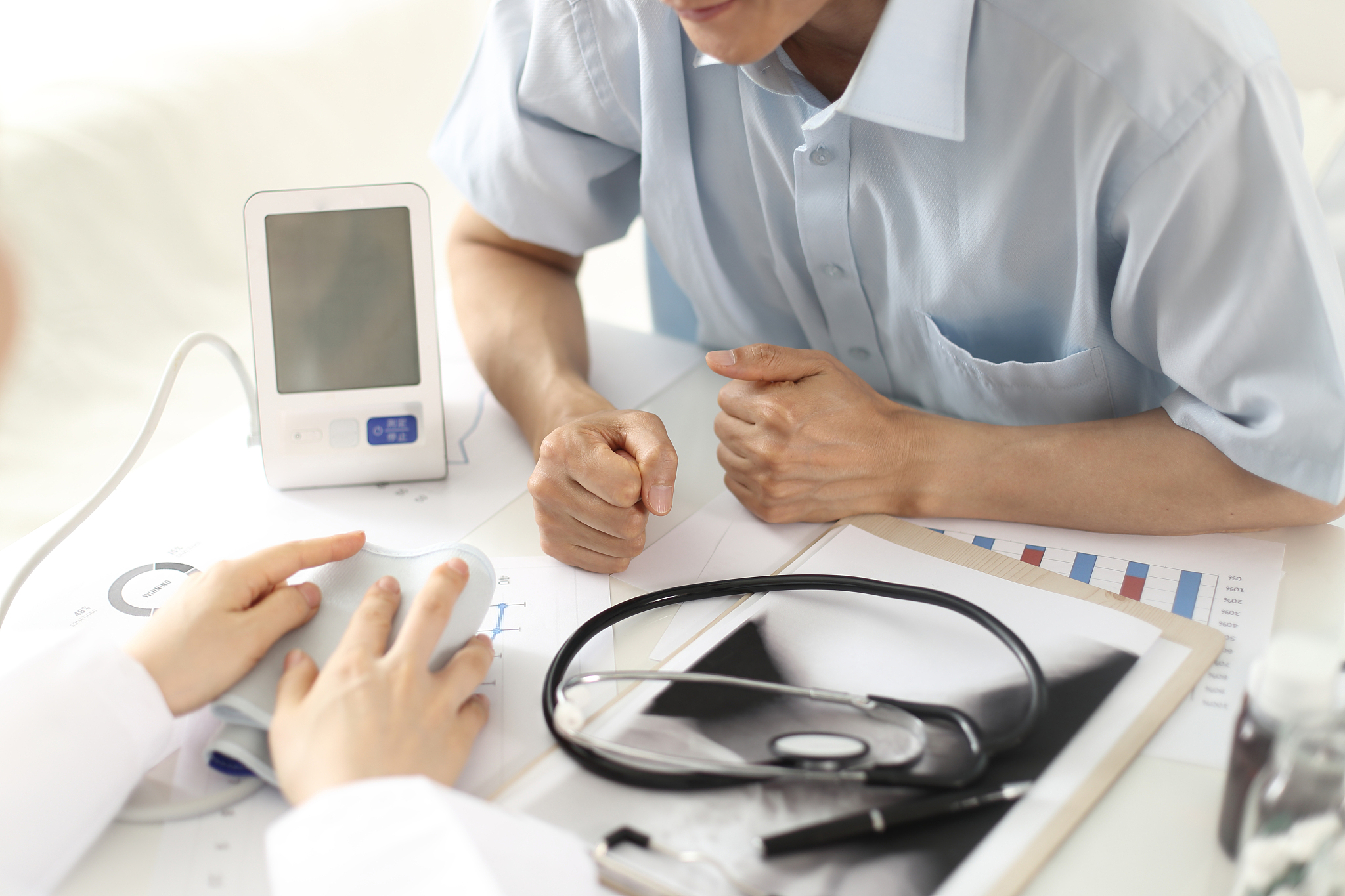doctor testing patient's blood pressure