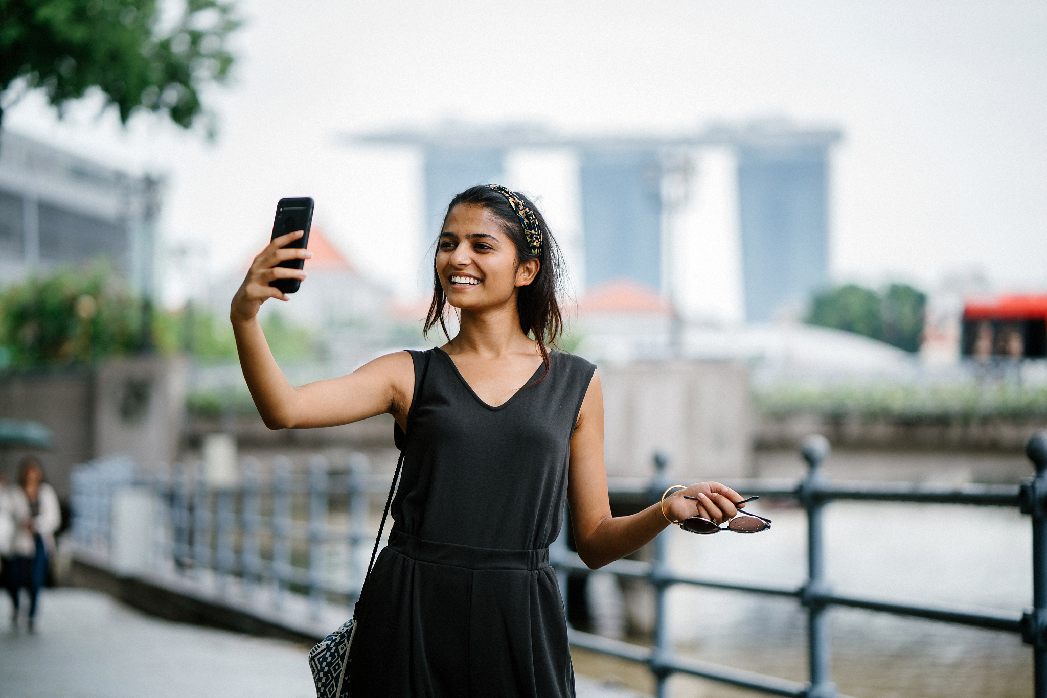 a young and attractive indian asian woman takes a selfie of hers