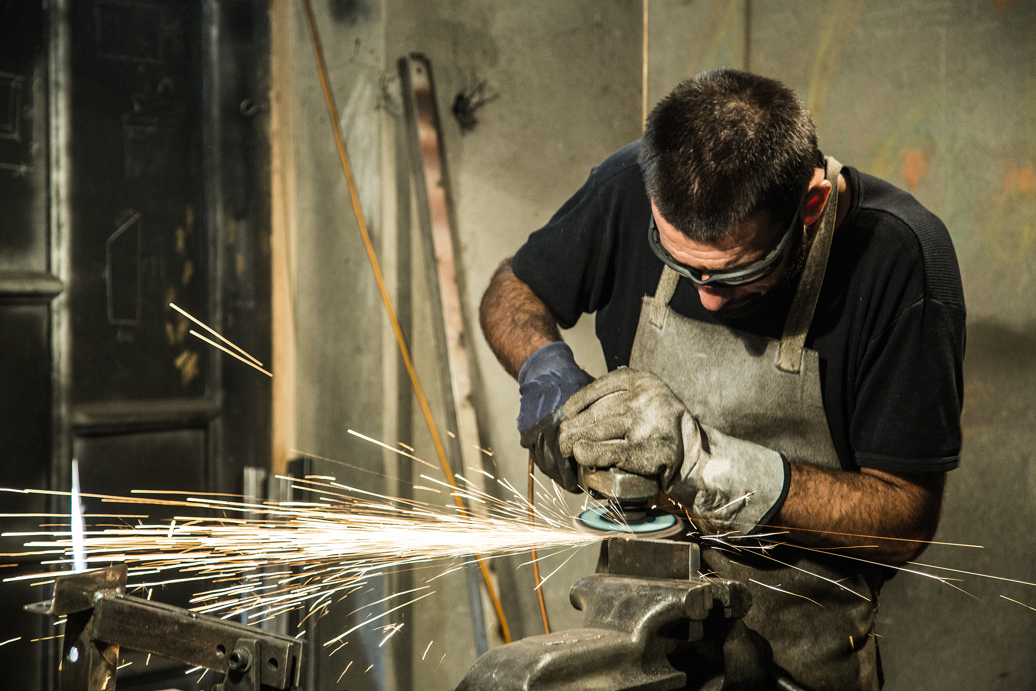 small business owner grinding at his garage