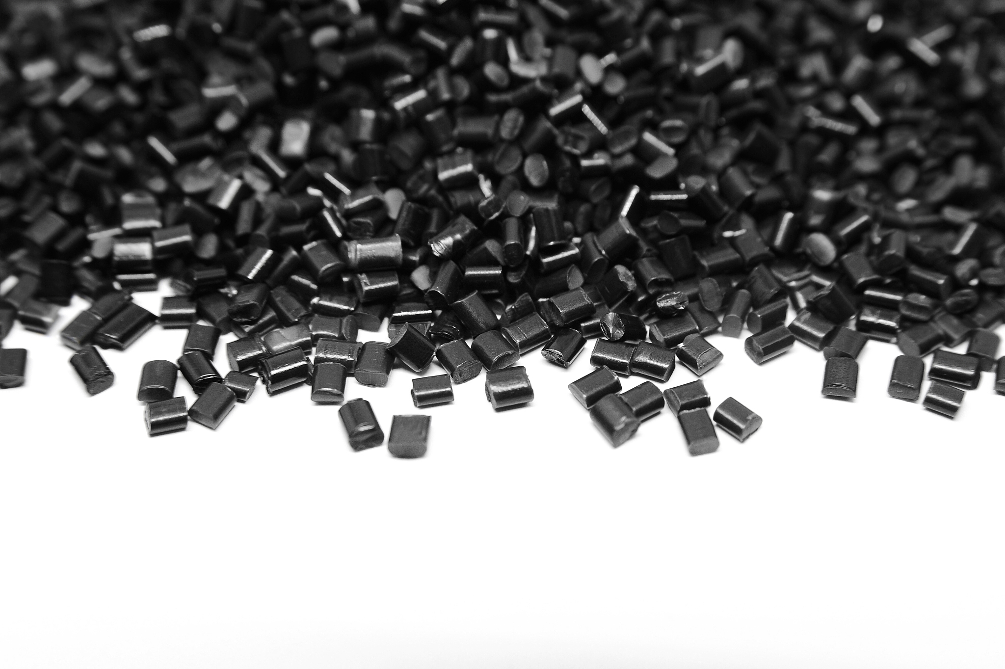 black plastic polymer granules isolated on white