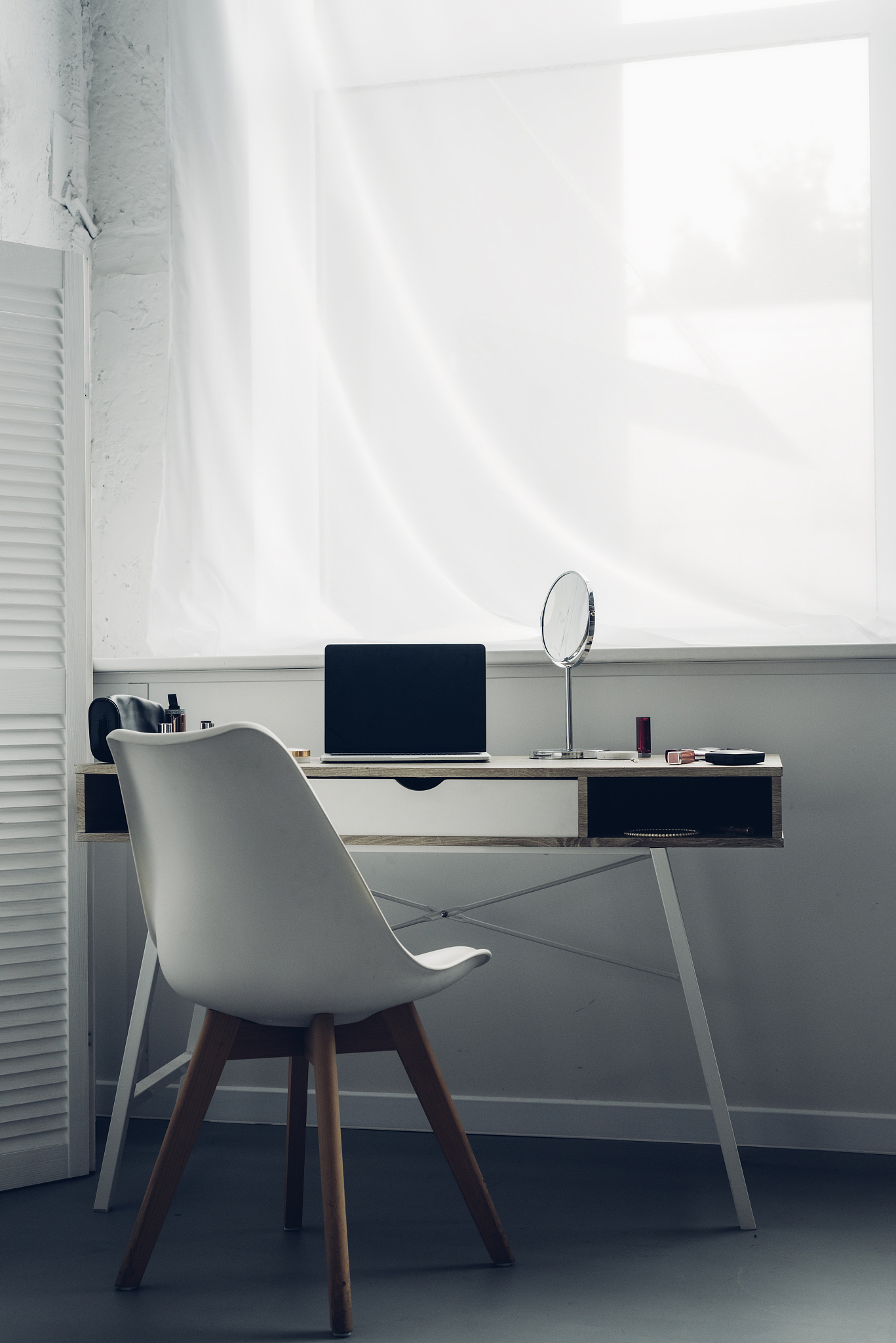 modern workplace with laptop and makeup supplies at home