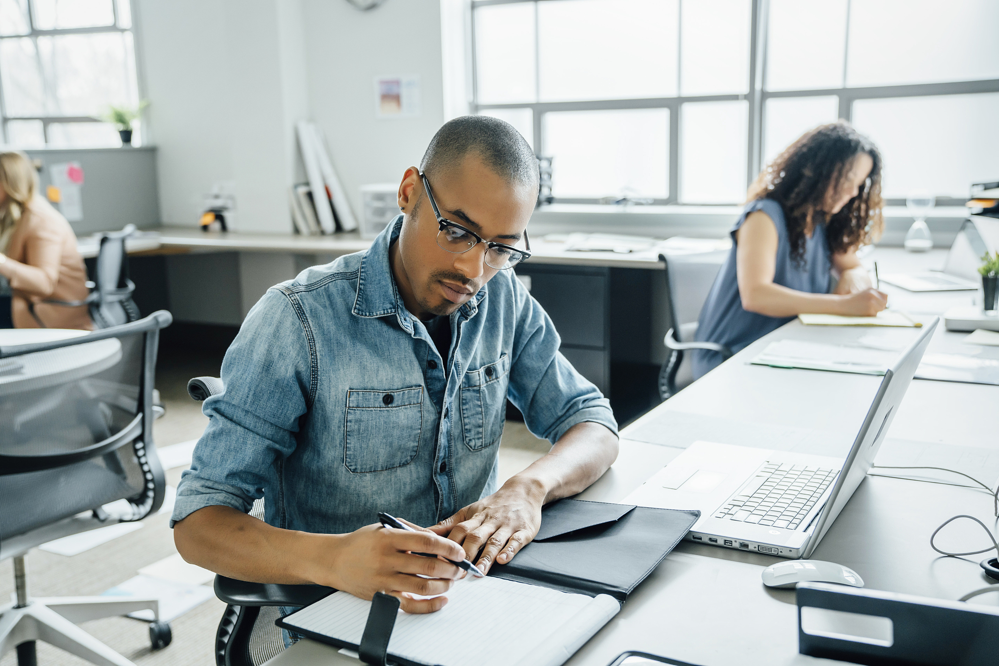 man using note pad in office