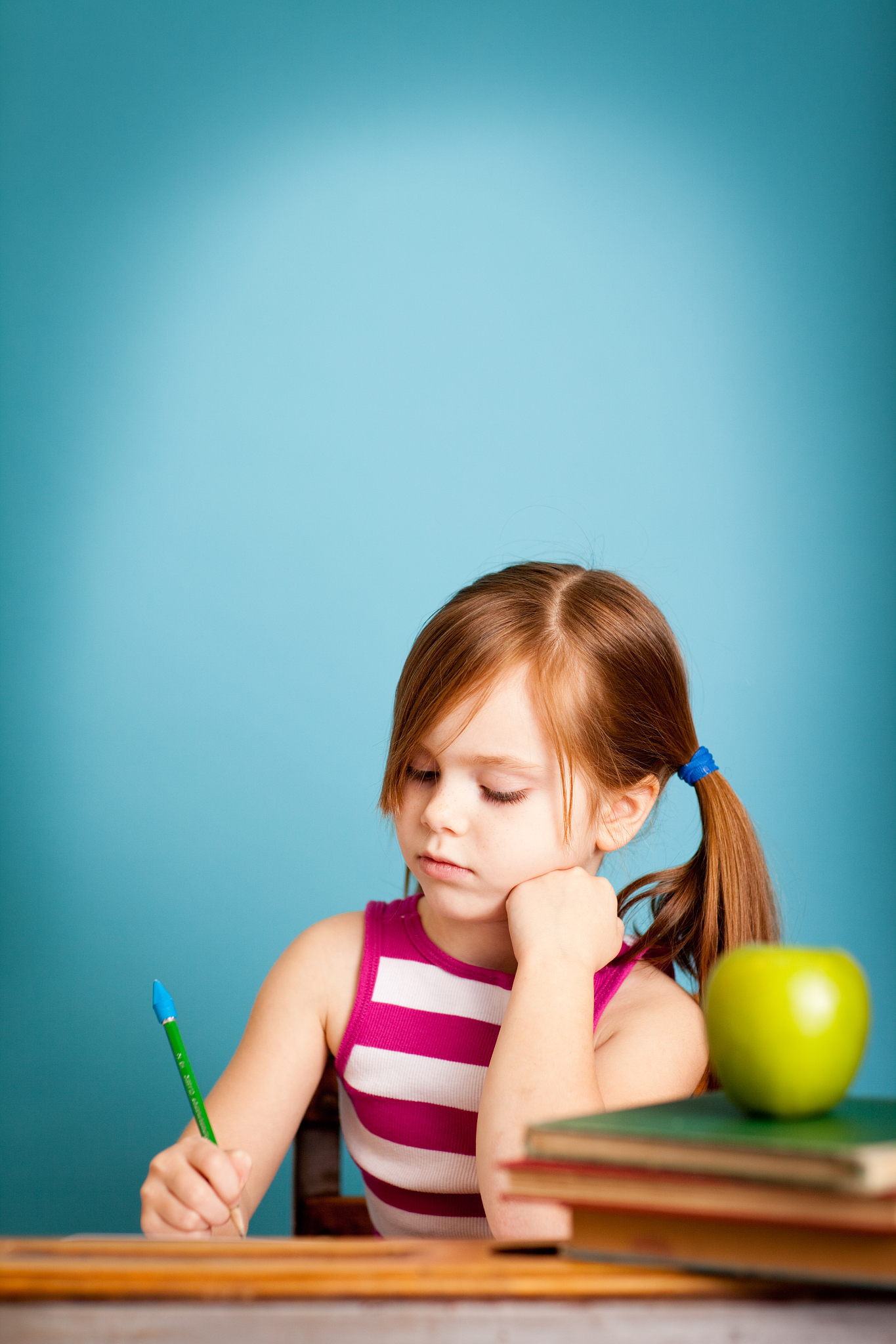 young student sitting at desk doing work, with copy space