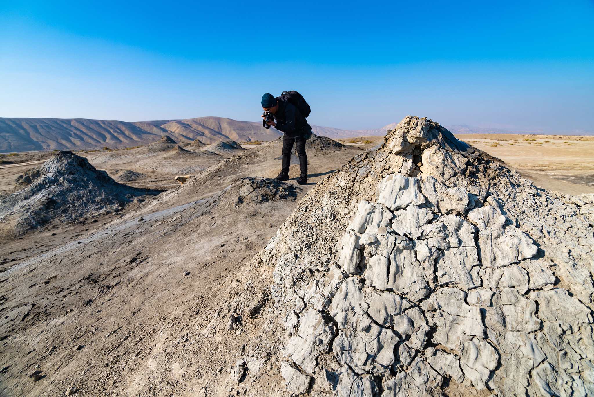 mud volcano with tourist in background in gobustan national park