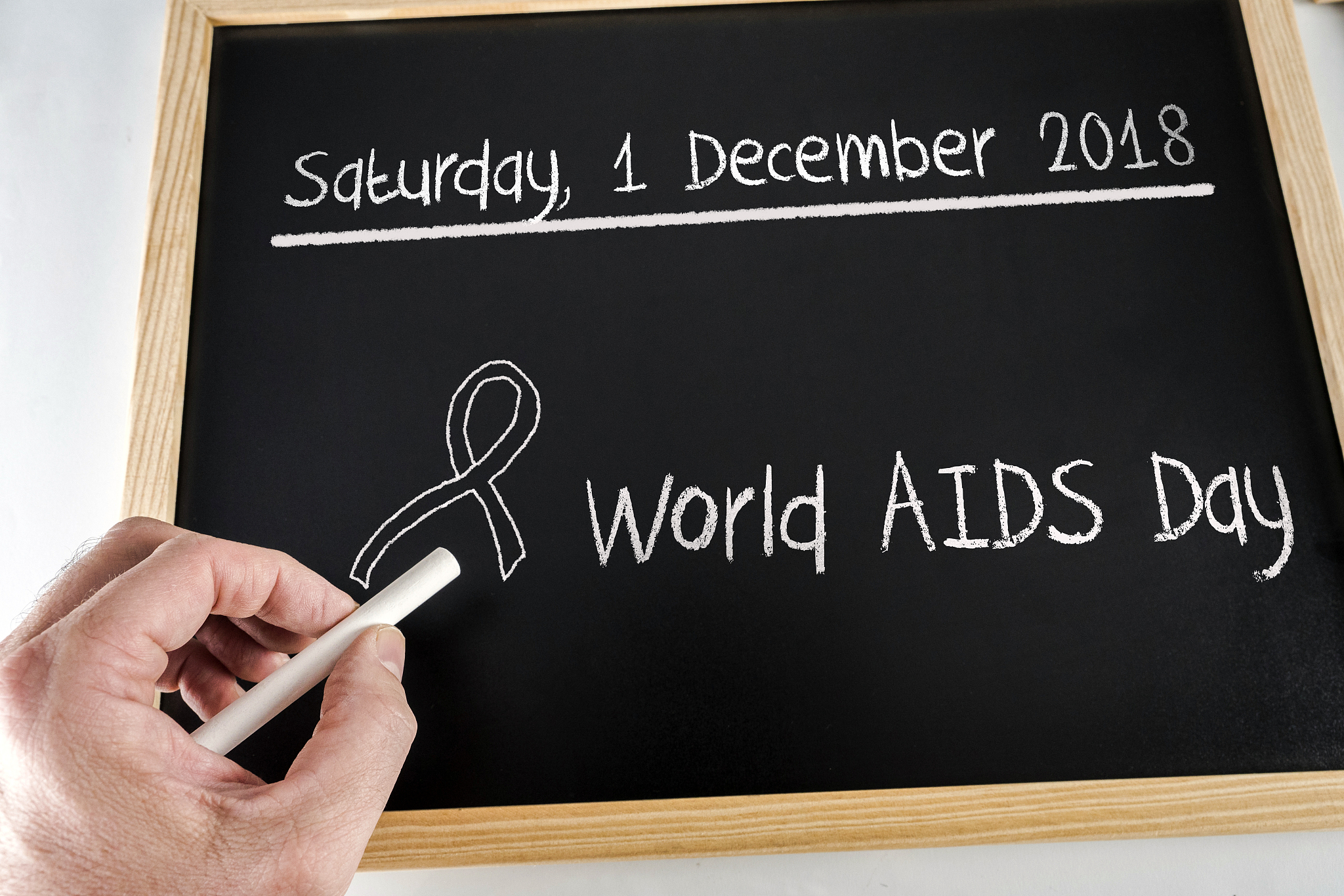 written on a chalk slate date of celebration of the world aids d