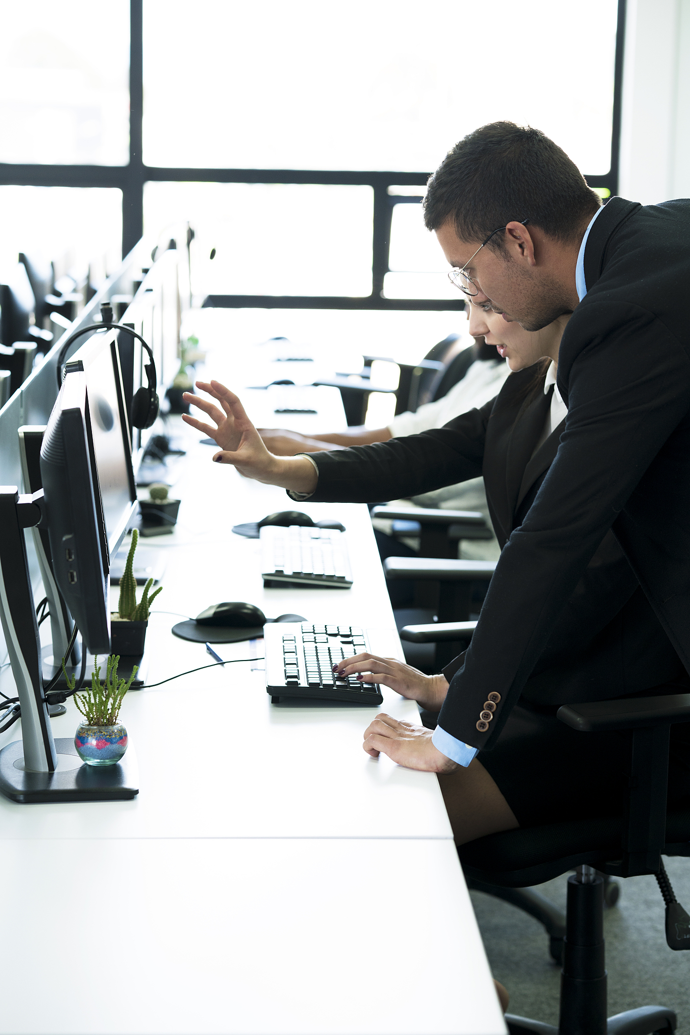man and woman working in an office