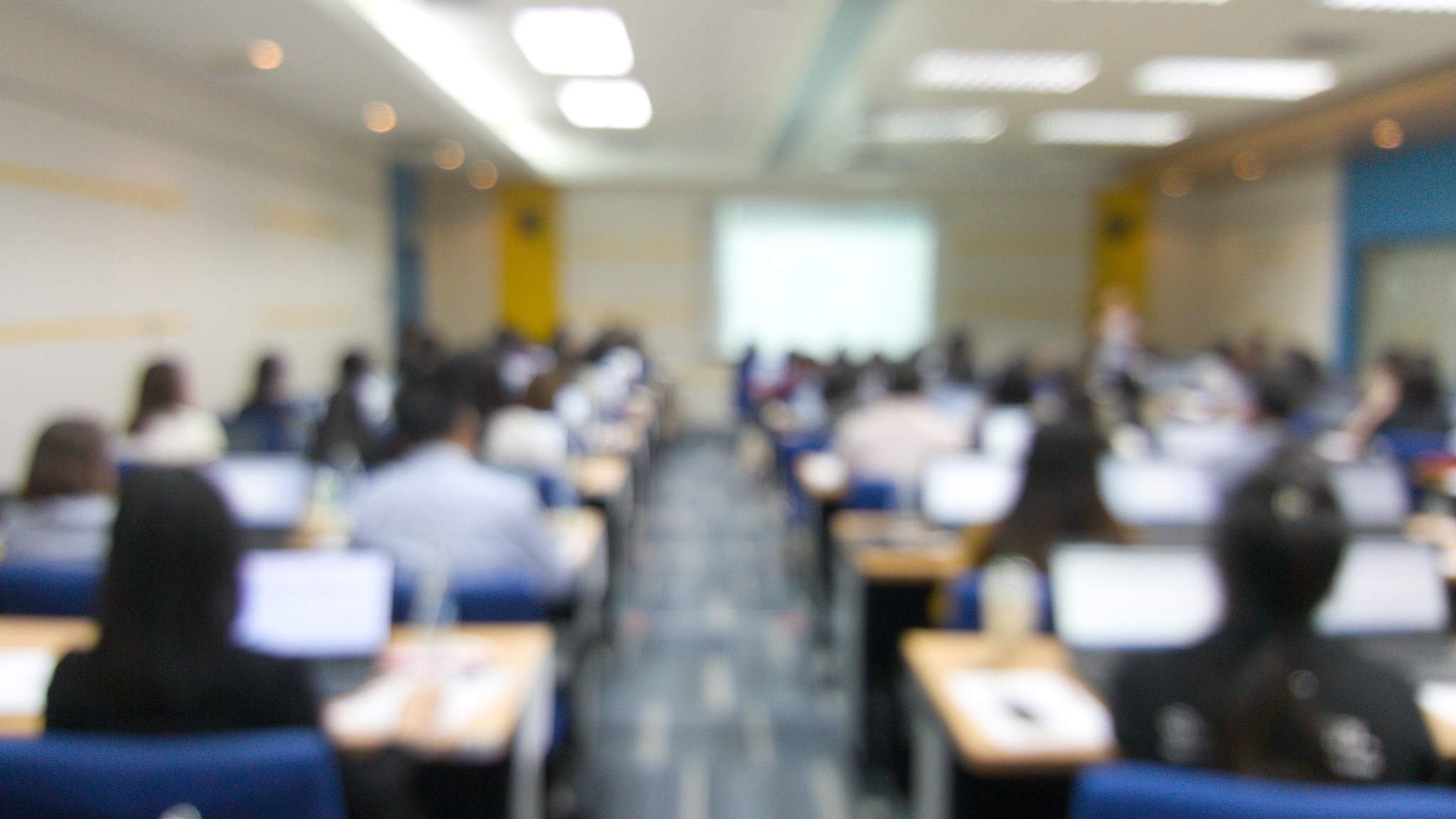 blur image of many people are training in the big training room 
