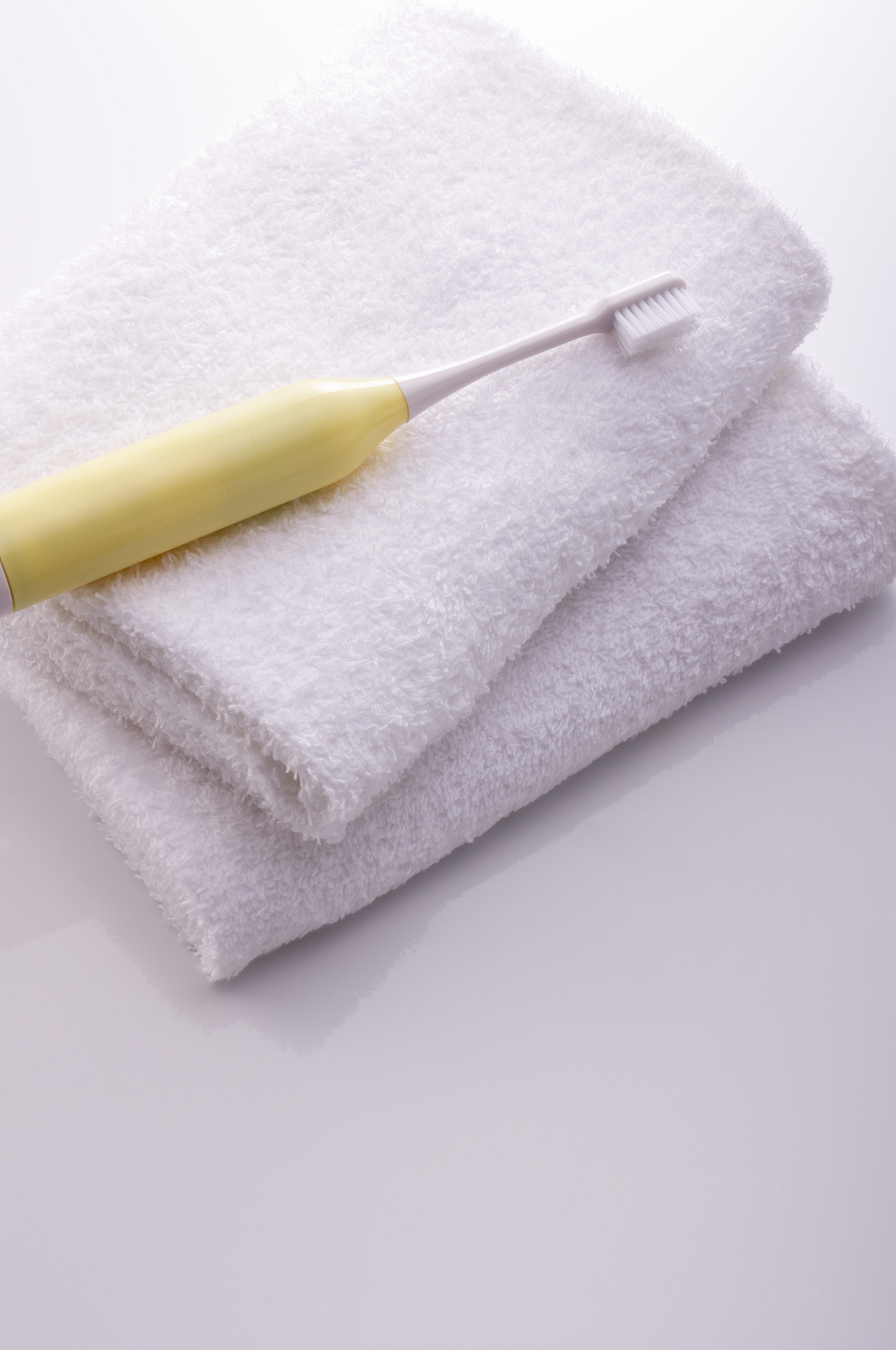toothbrush on white towel