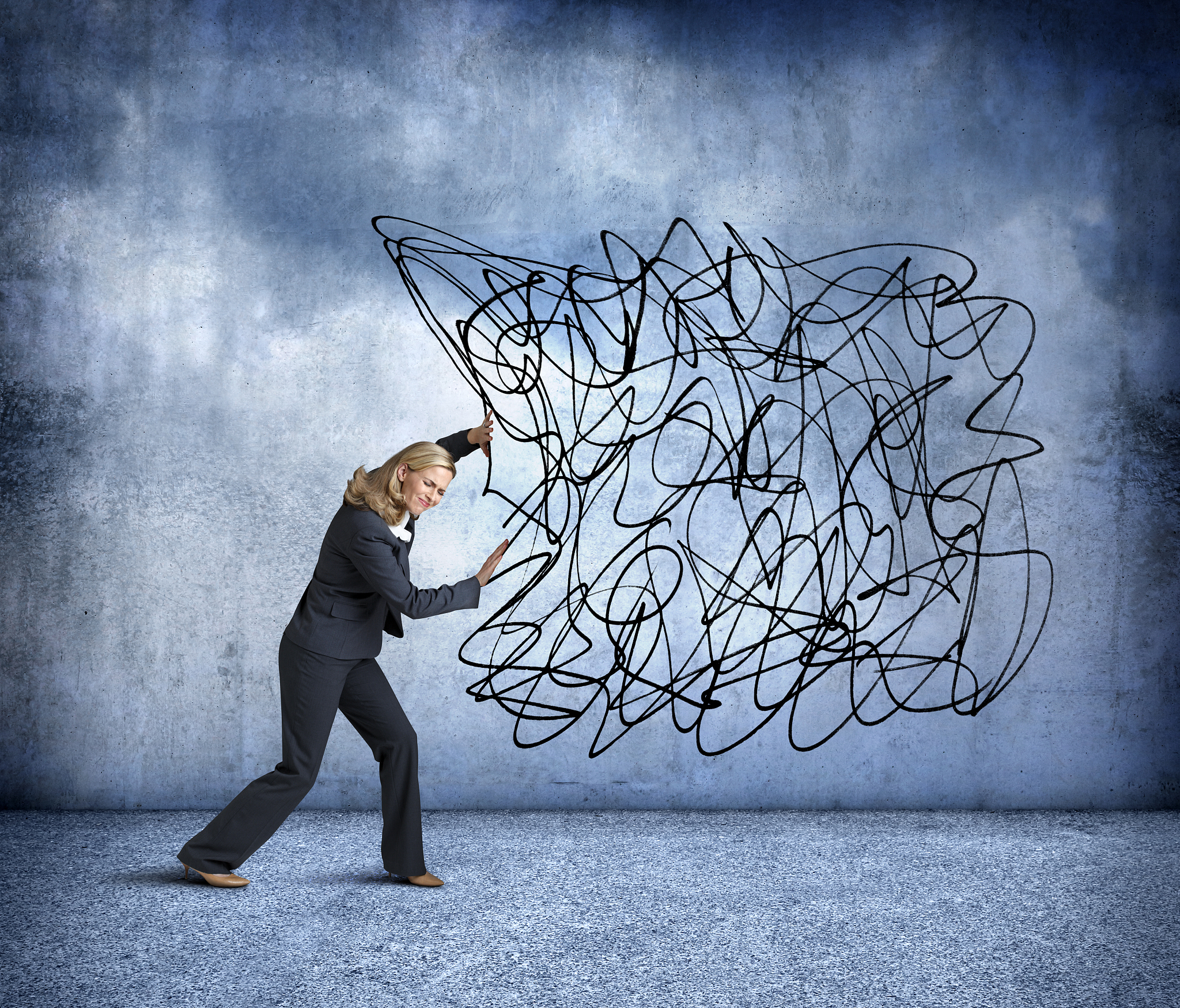 woman pushing a large cloud of scribbled lines