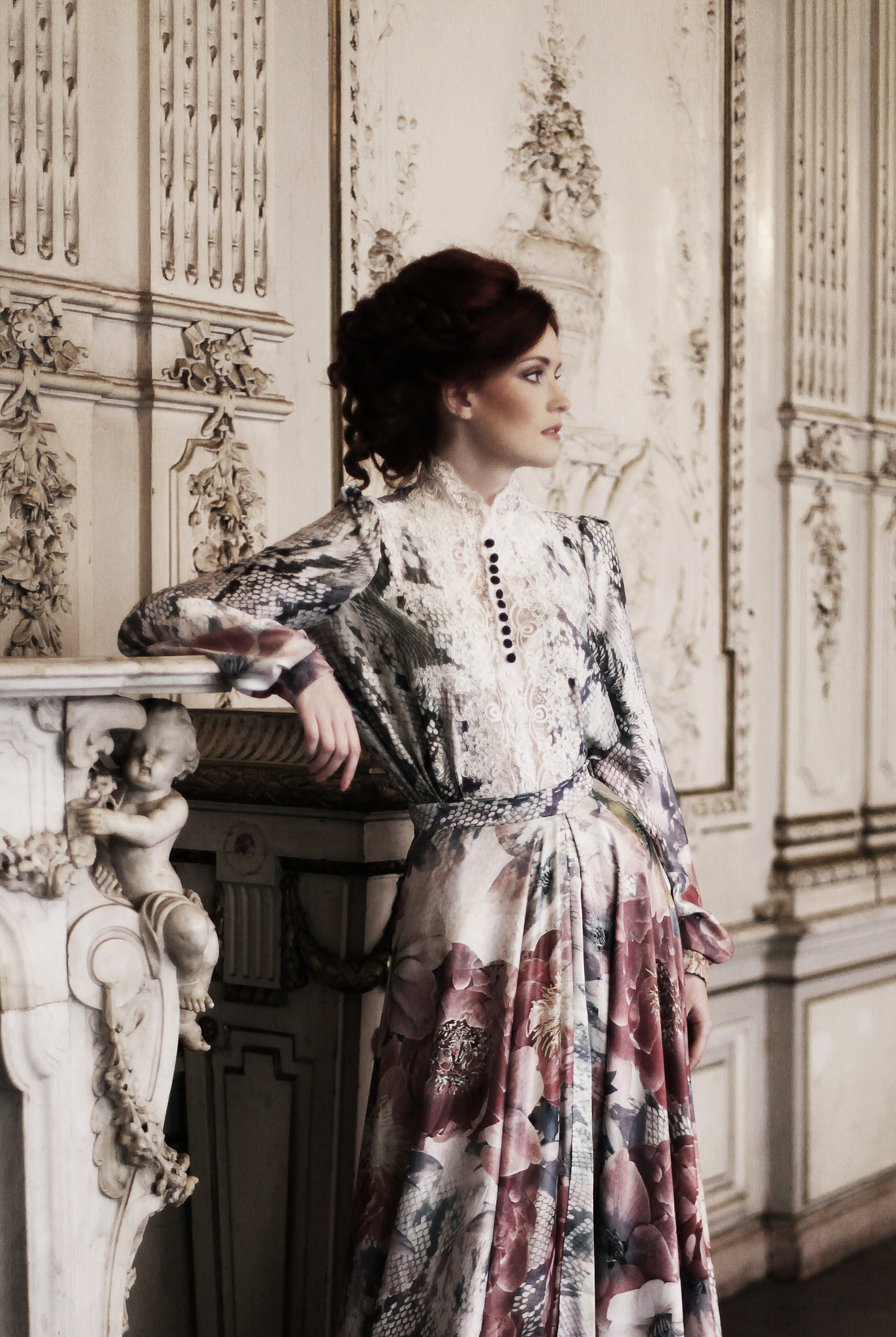 woman  posing next to the fireplace