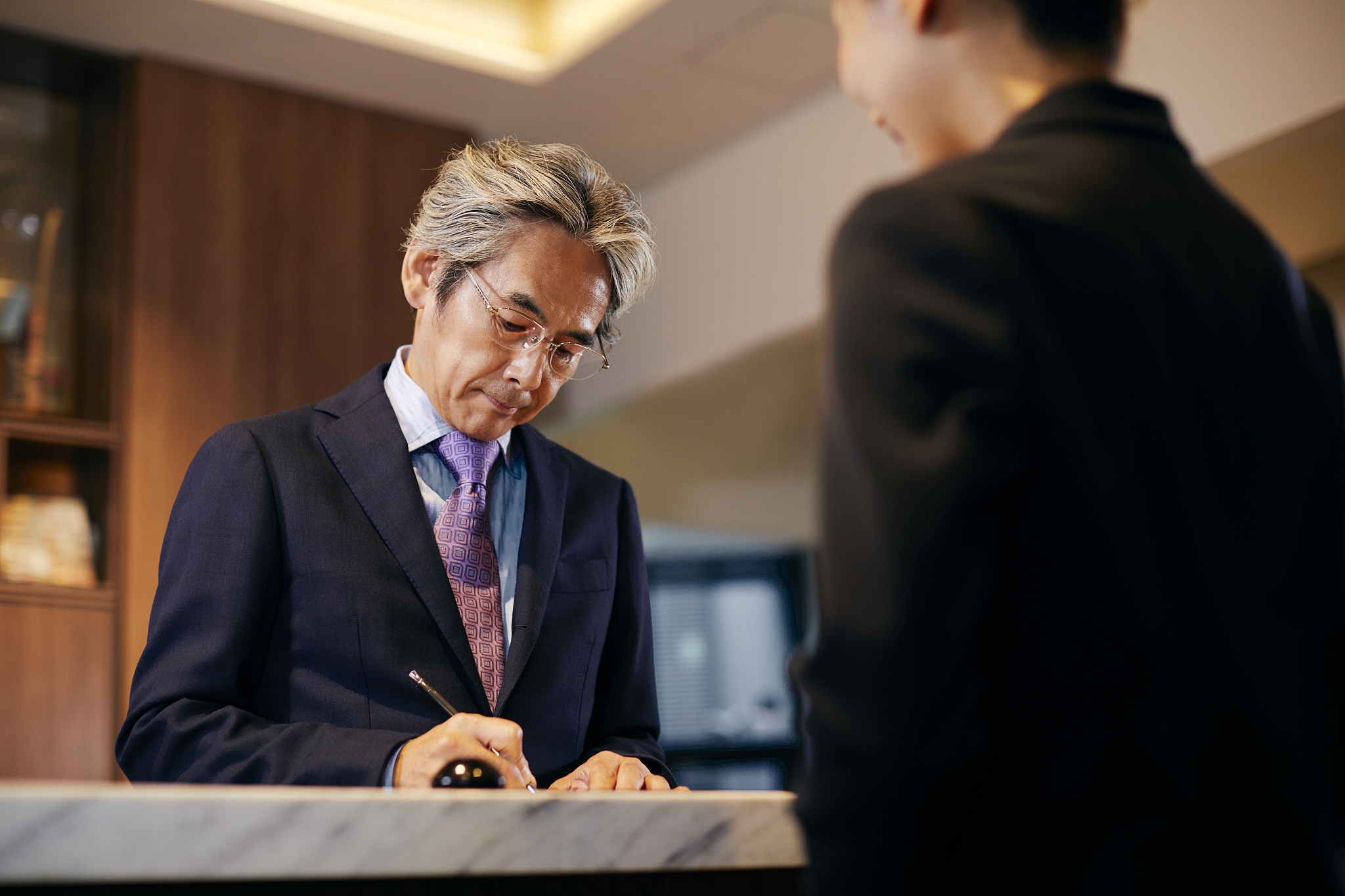 senior businessman checking in at hotel
