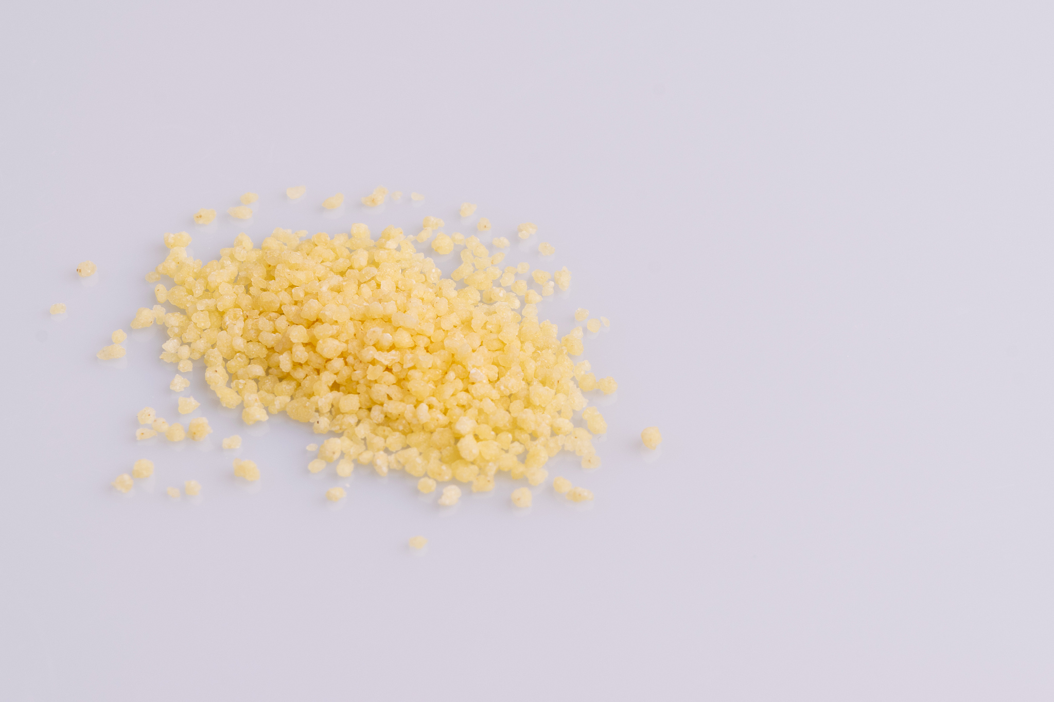 dry couscous isolated on white background, soft light, copy spac