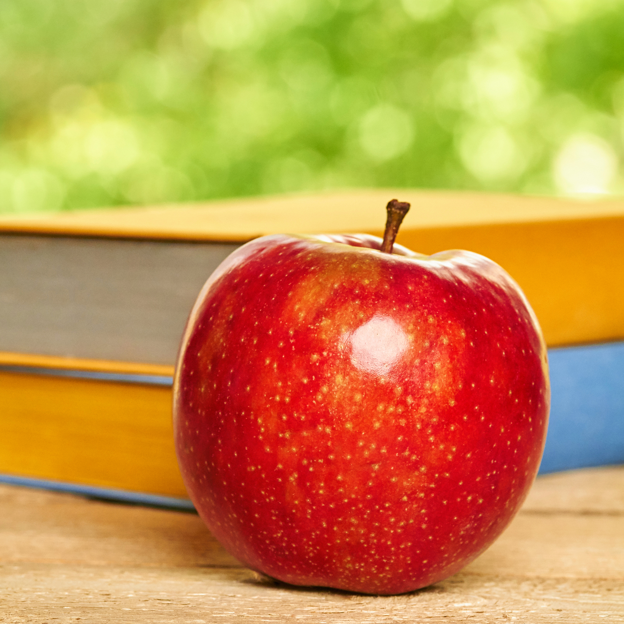 apple and stack of books