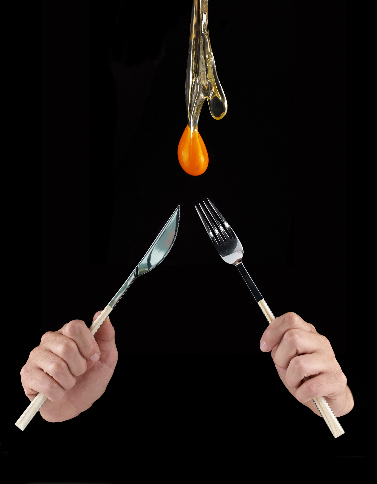 egg yolk dripping in to cup.