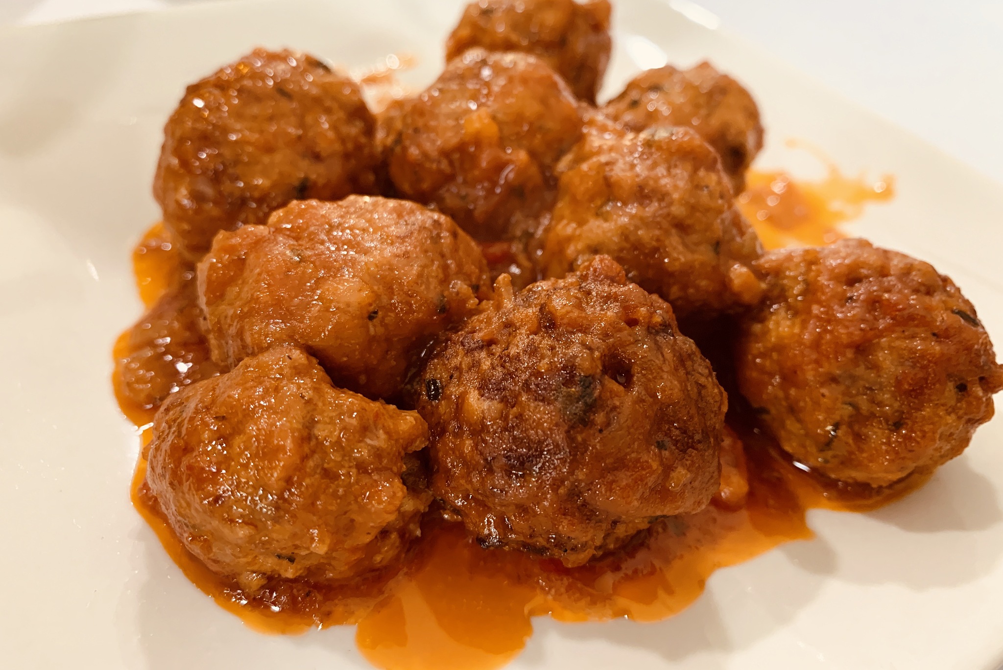 meatballs with tomato sauce, on a white plate. a traditional tap