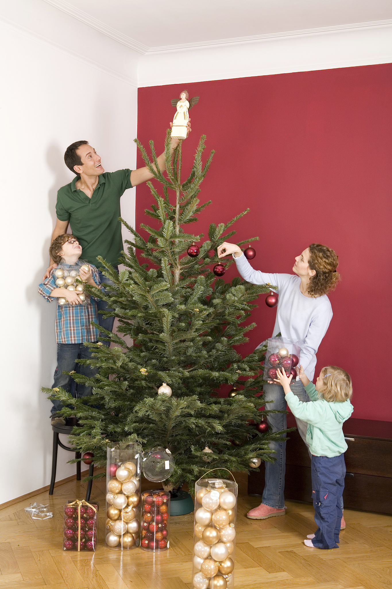 family decorating christmas tree