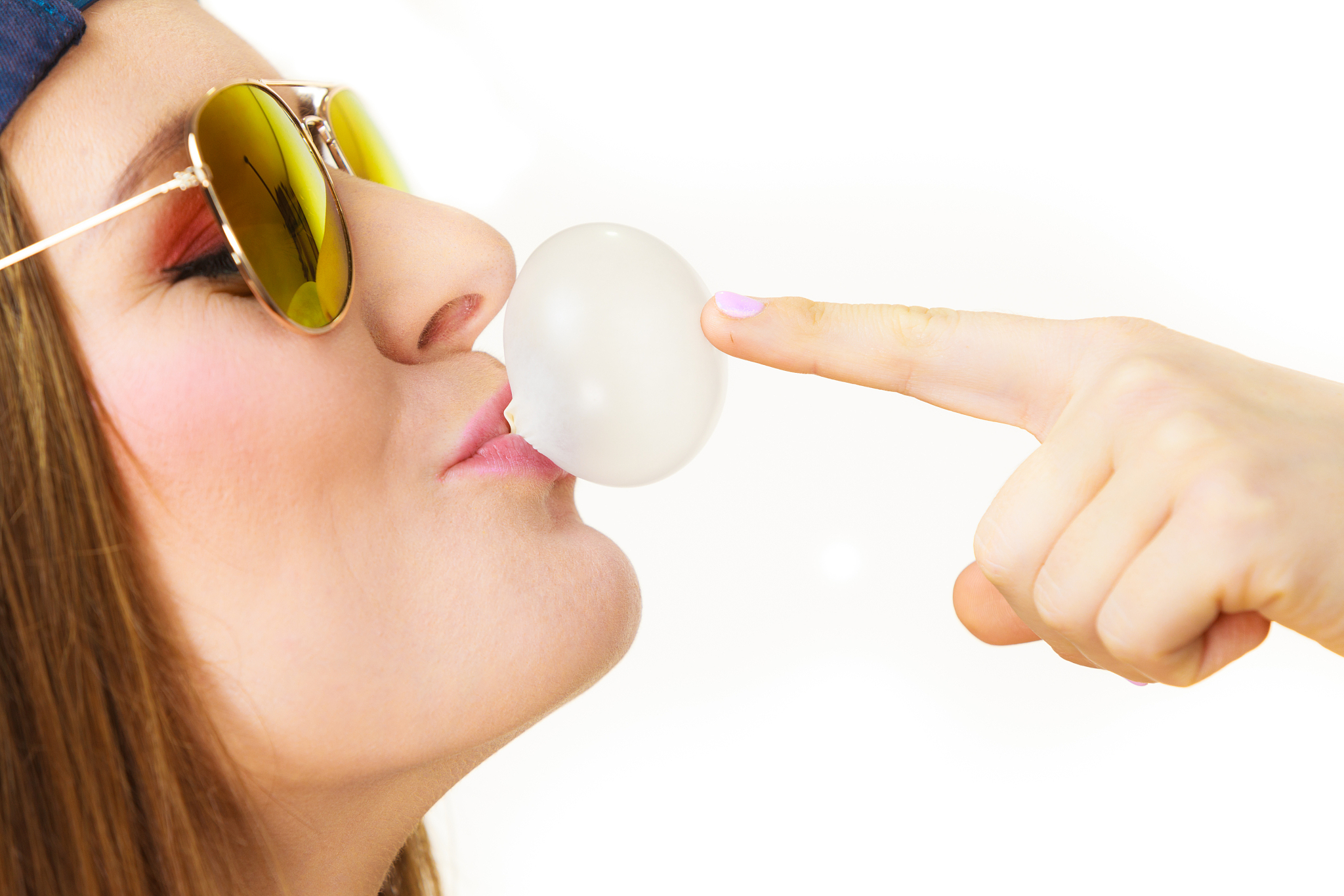 woman doing bubble with chewing gum