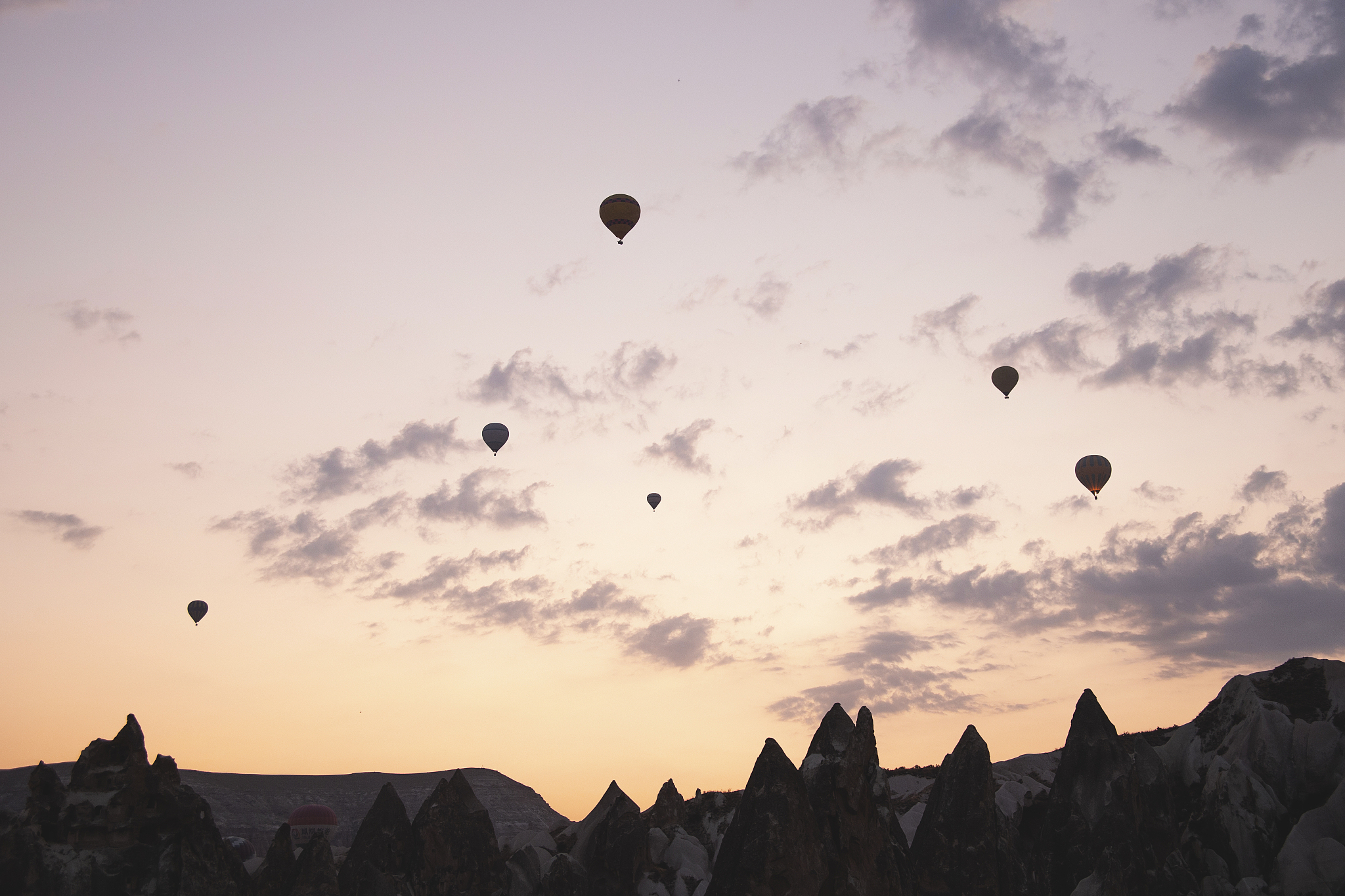 flying balloons against the background of the colored dawn sky