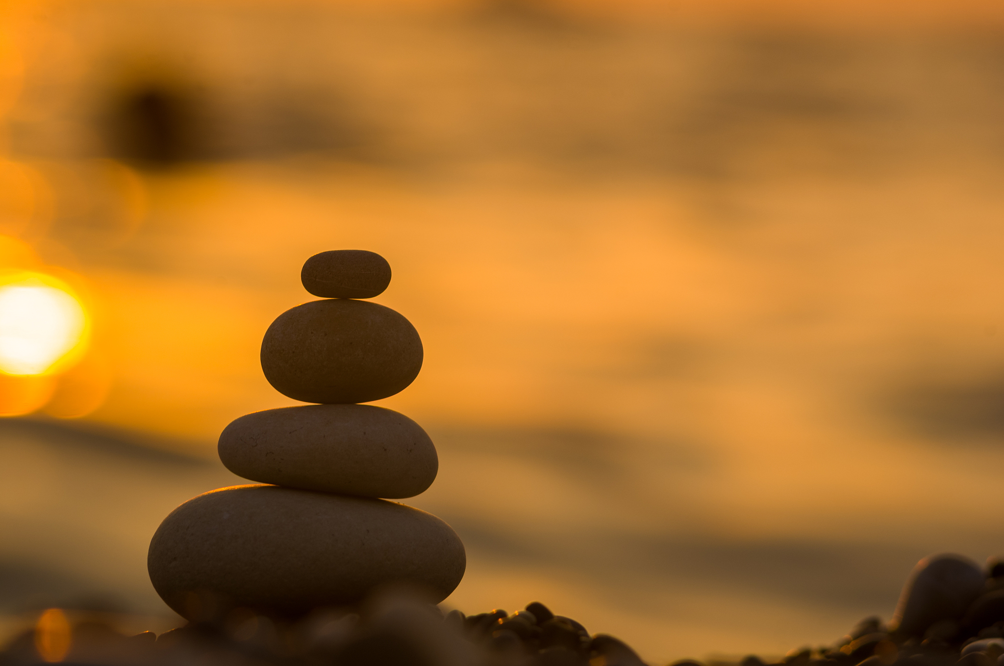 stack of zen stones on pebble beach