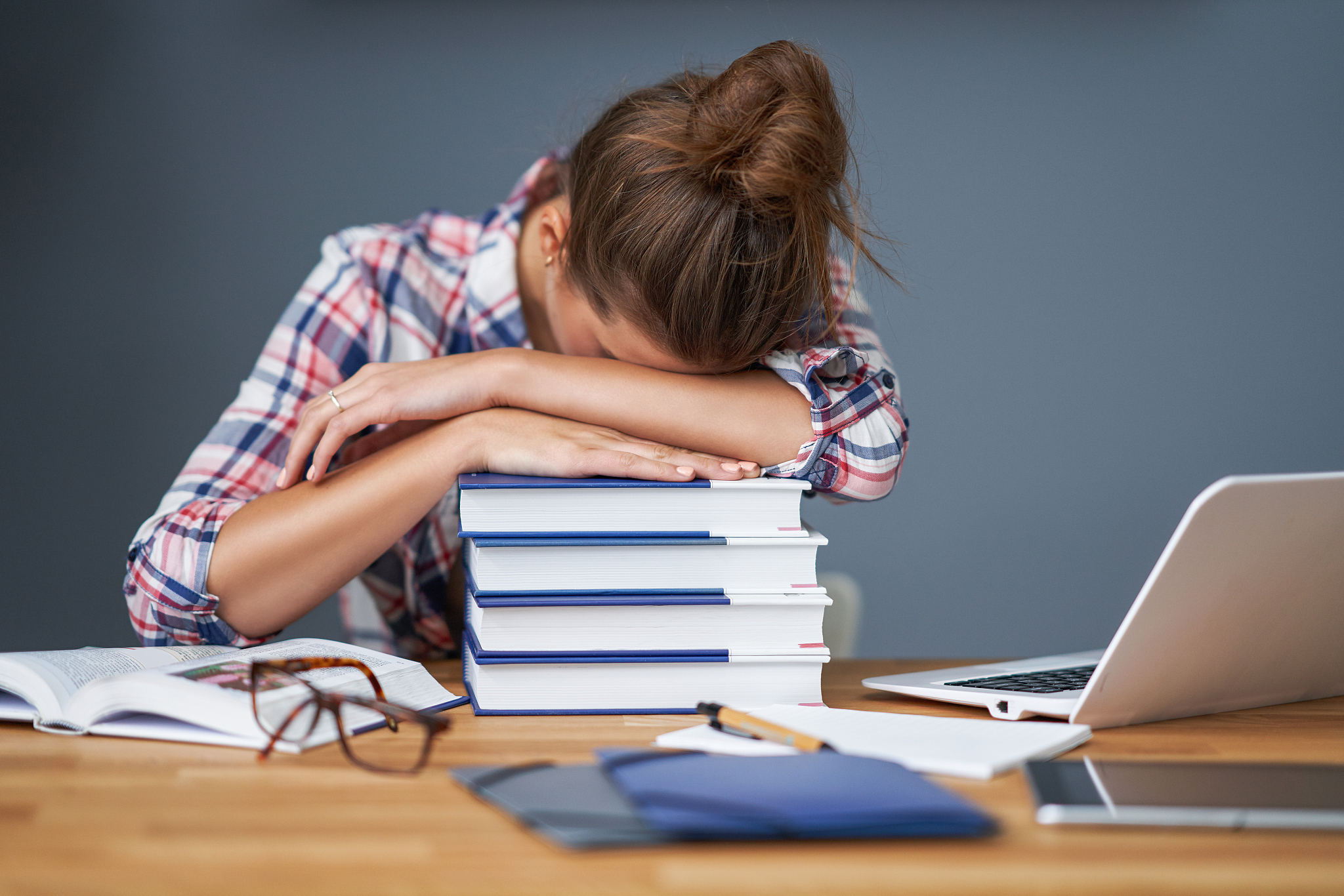 tired female student learning till late at home