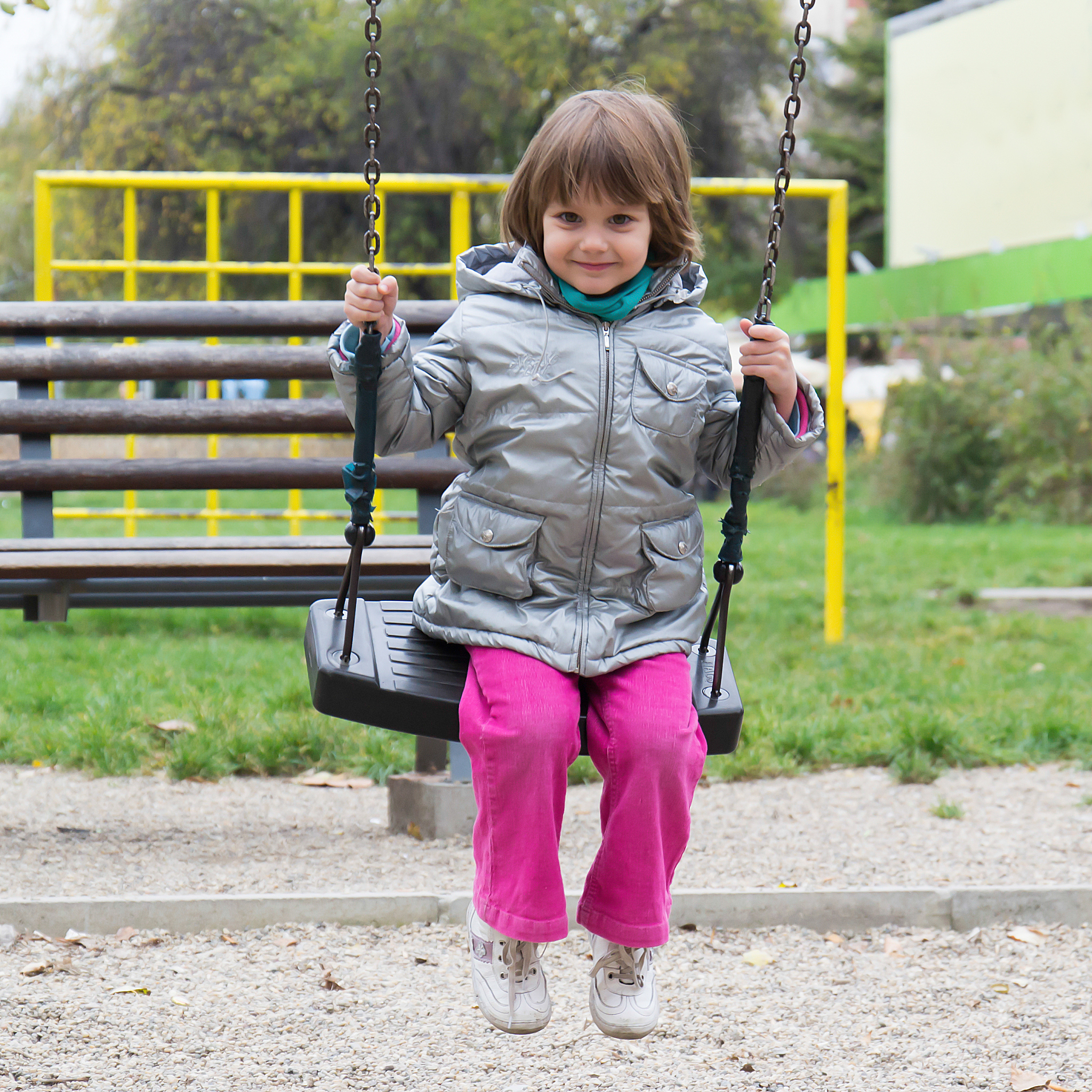 little girl on swing at playground