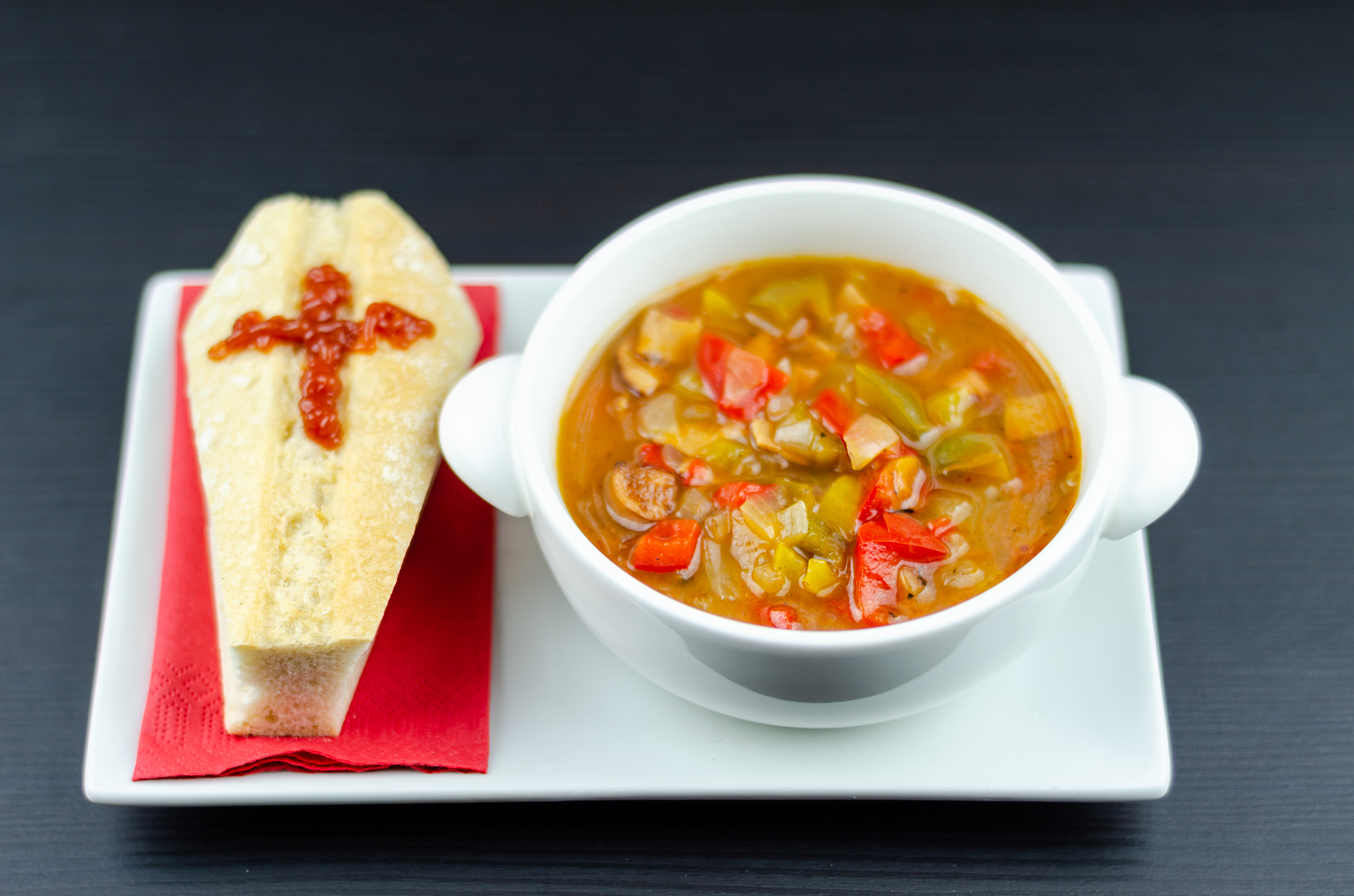 a delicious stew in a white ceramic bowl served with bread in th