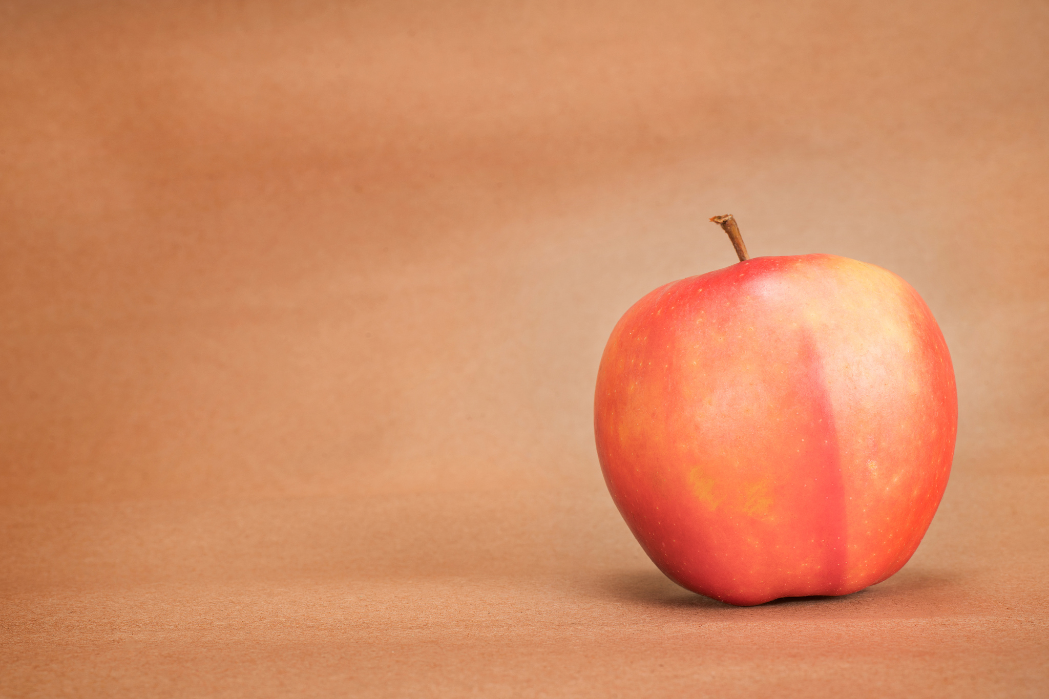 red apple on craft paper background