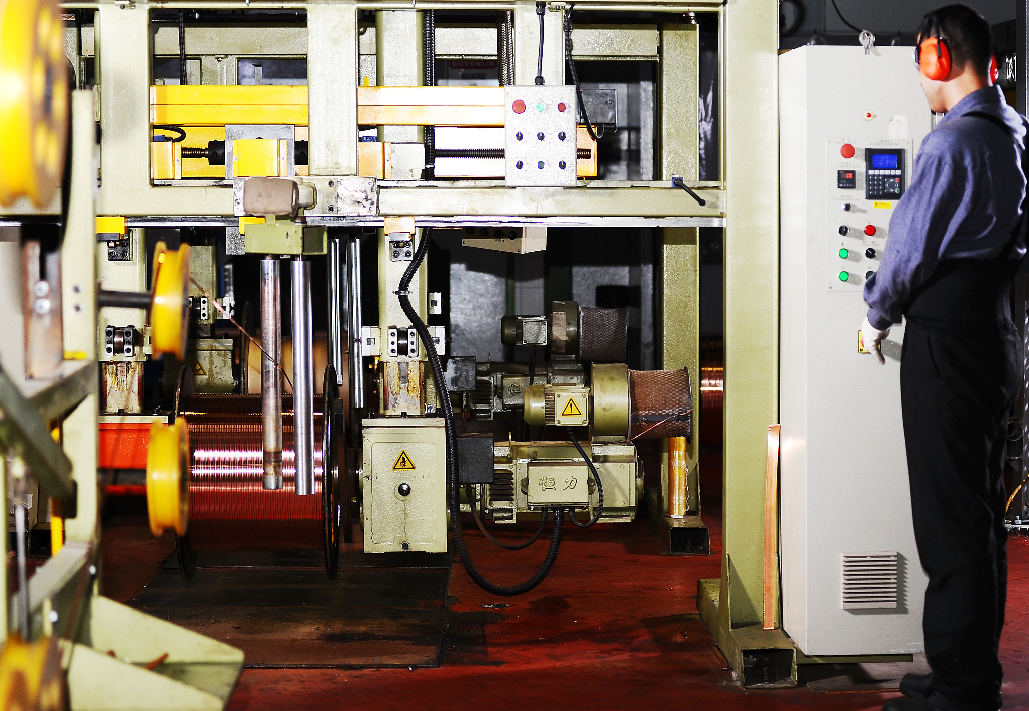 young man operating wire machine