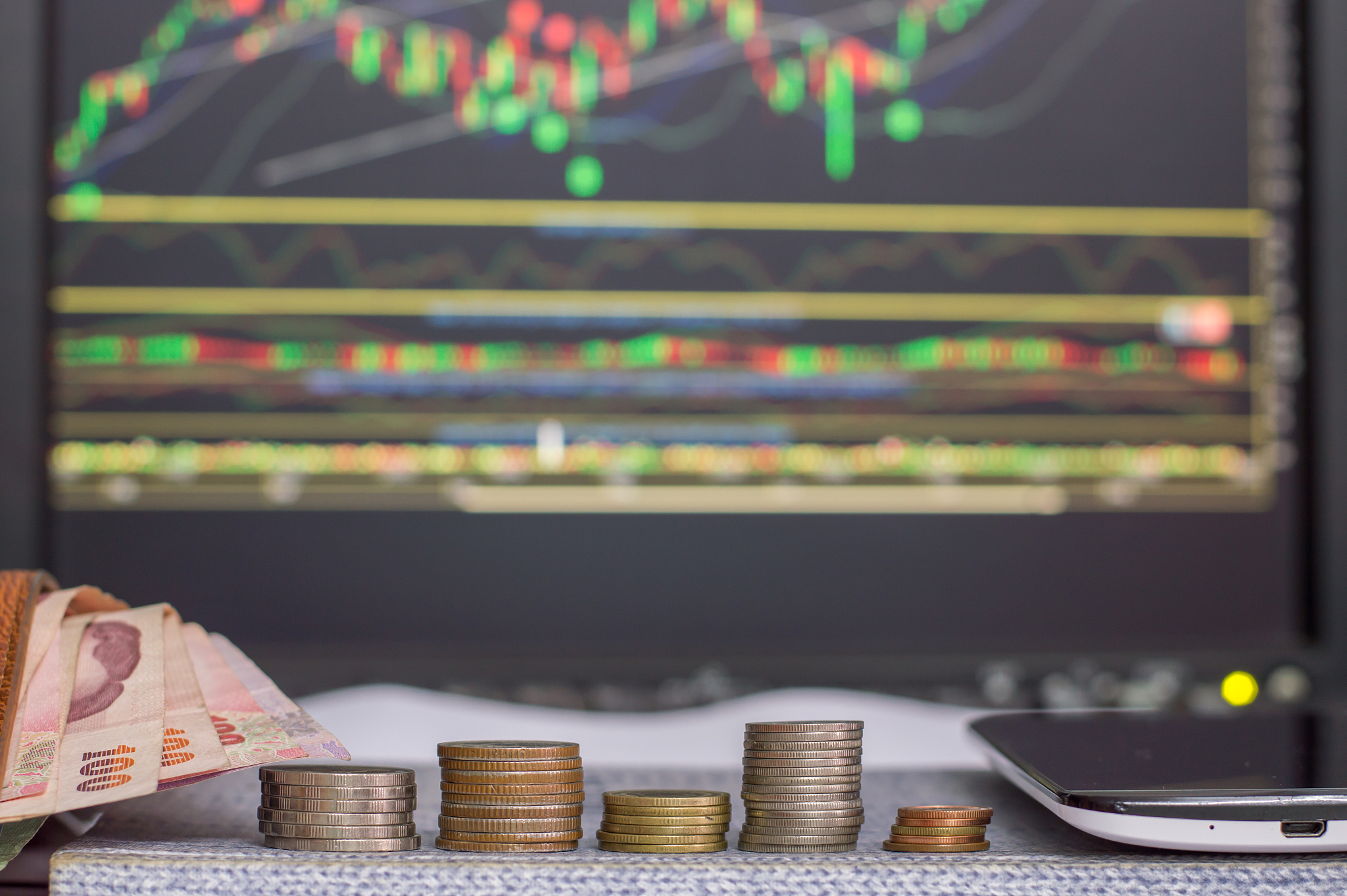 investment concept, coins, graph stock market background, thai m