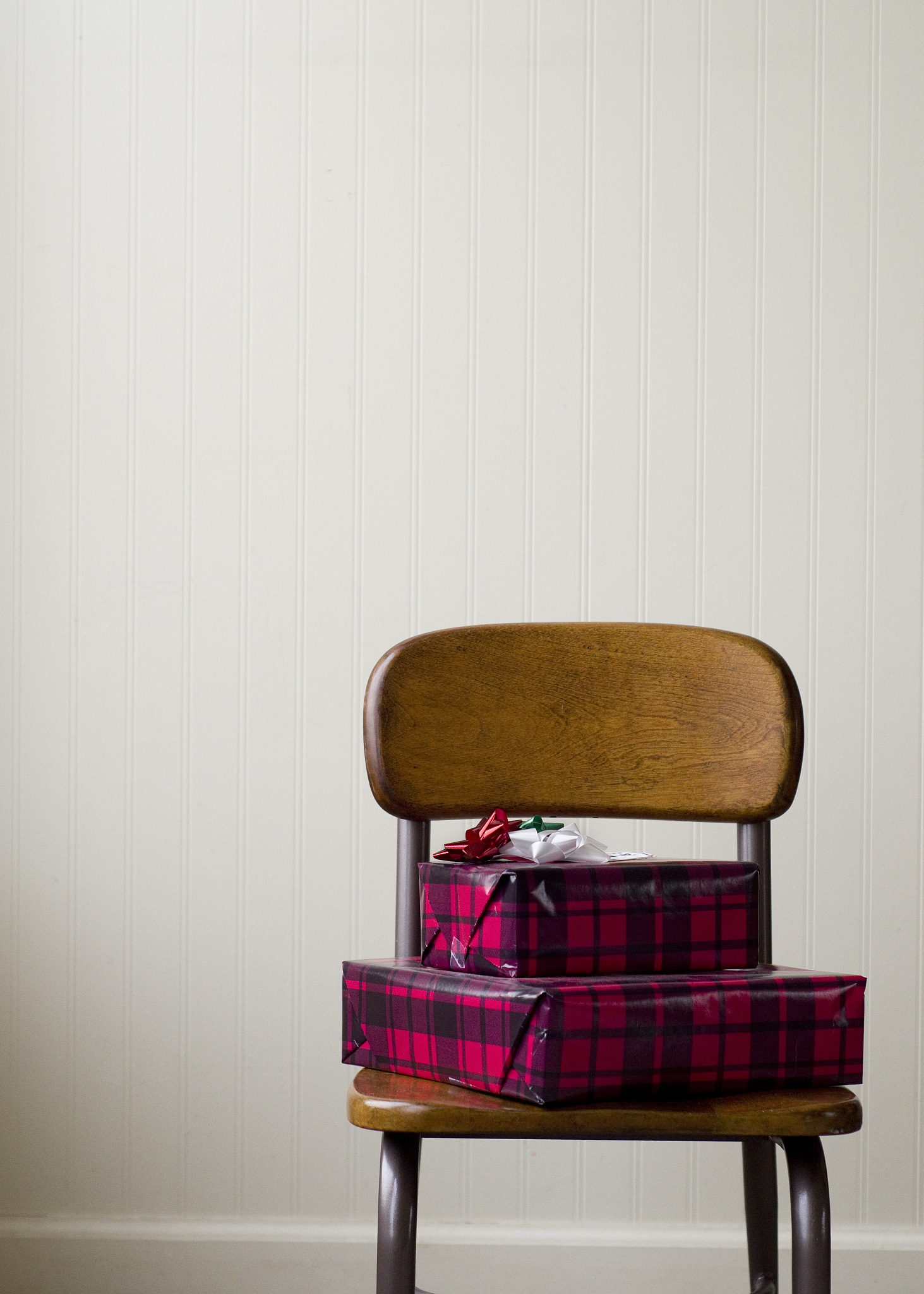 stack of wrapped gifts on a chair