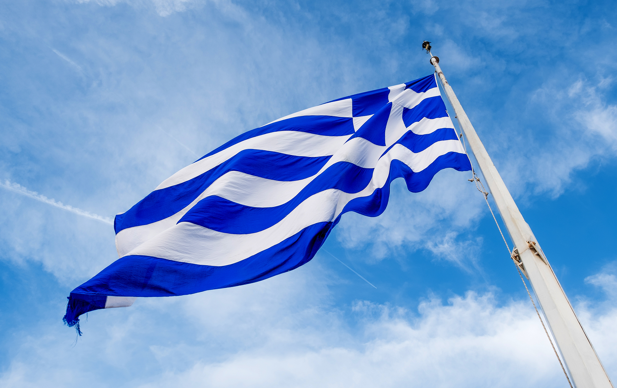 greek flag waving against blue sky