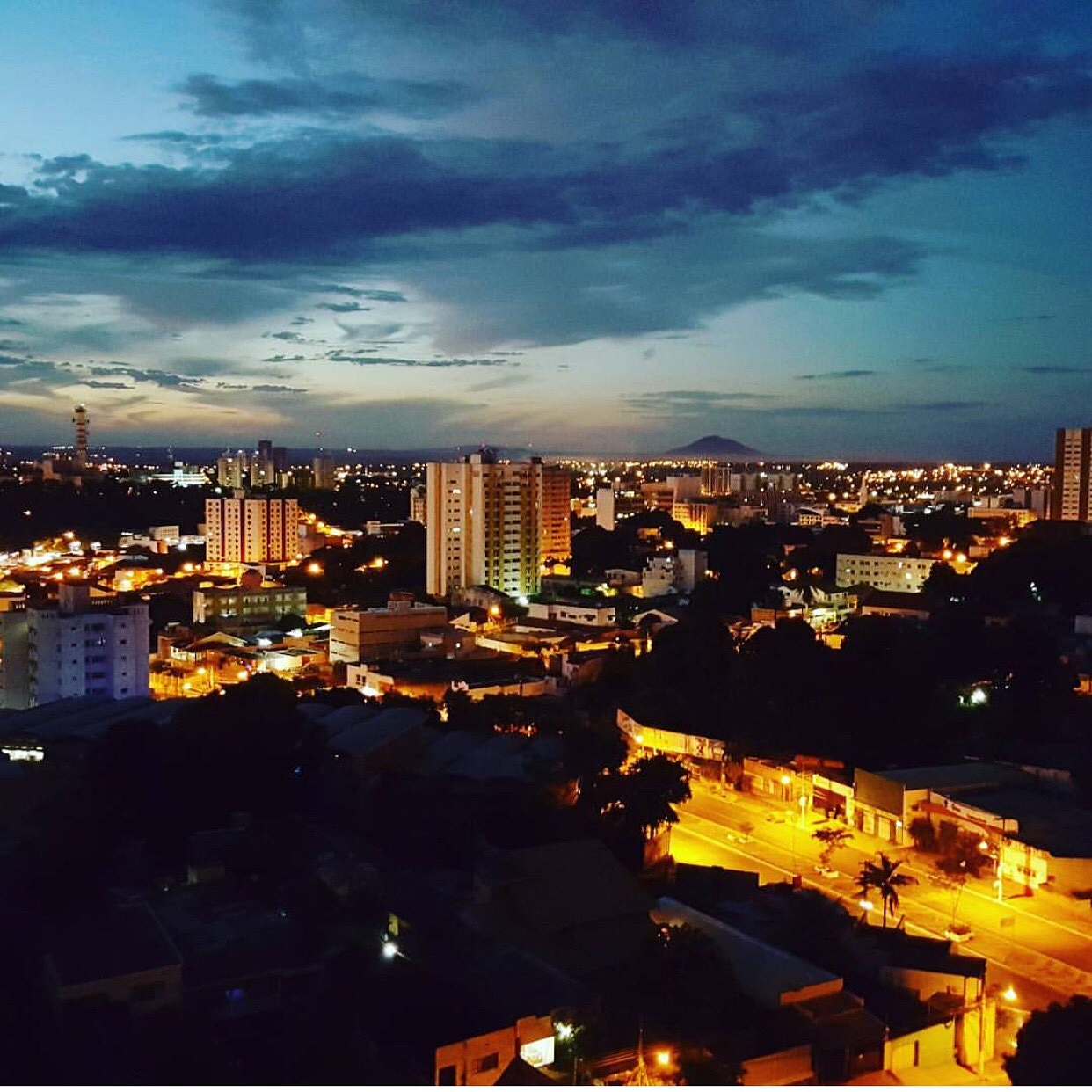 illuminated cityscape against sky at night