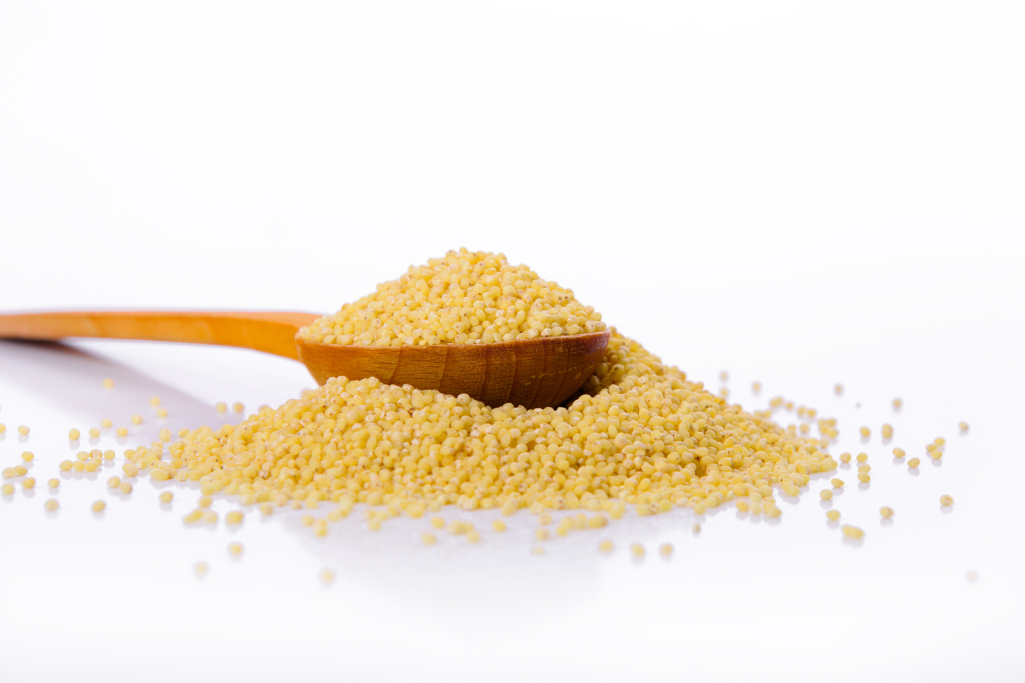 millet in a wooden spoon