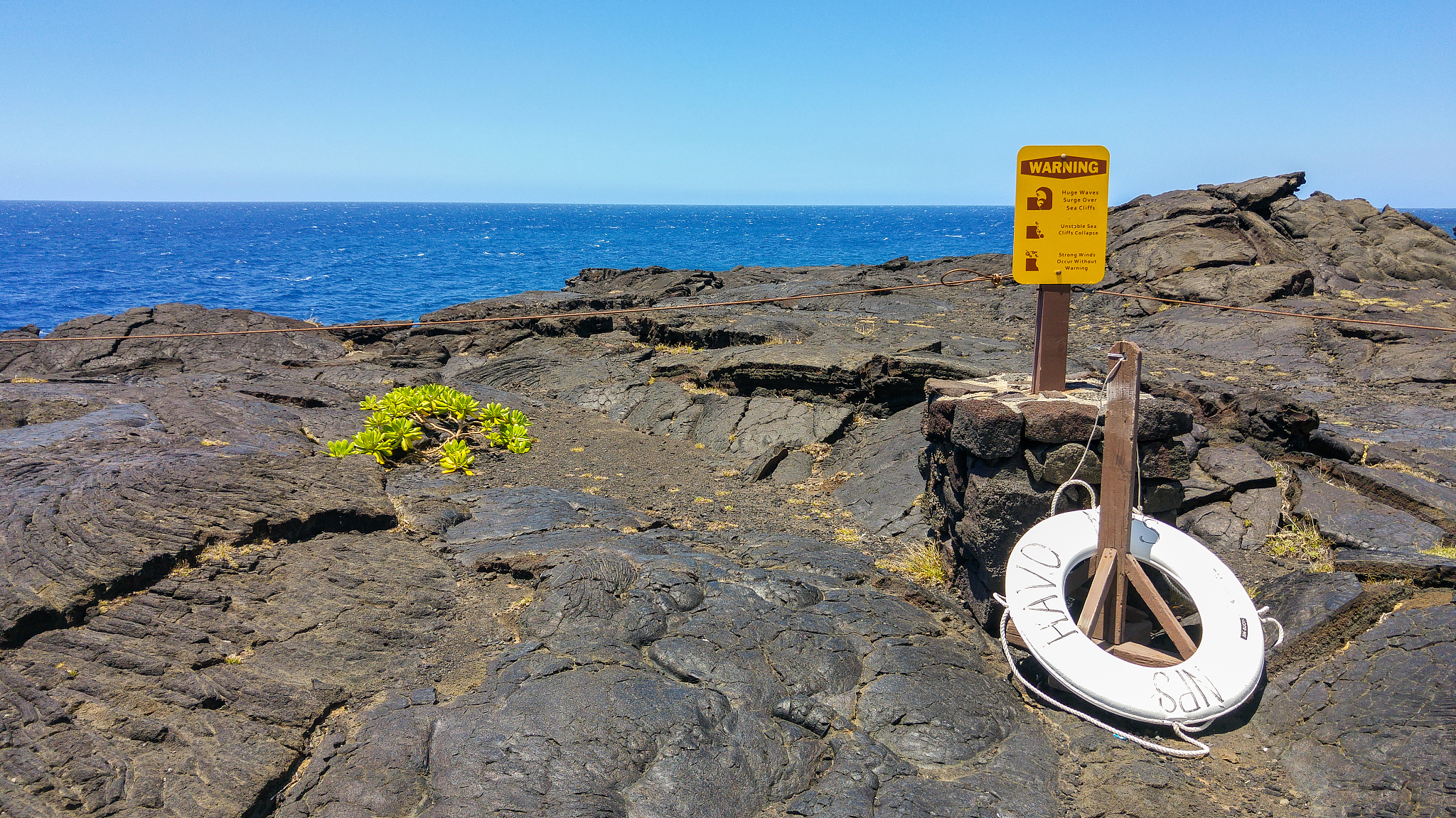 close-up of information sign on beach against clear sky