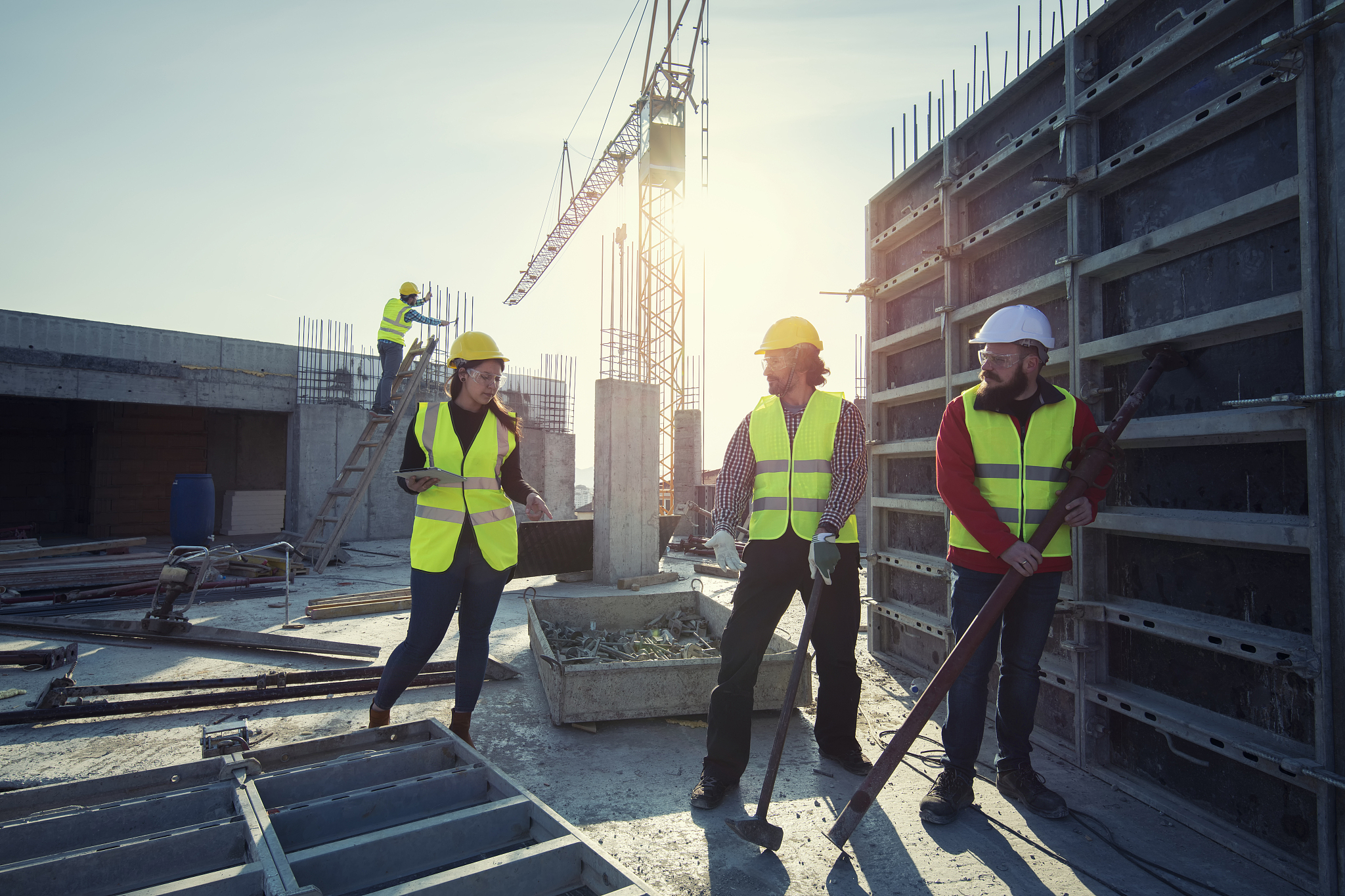 young architect and three construction worker on construction si