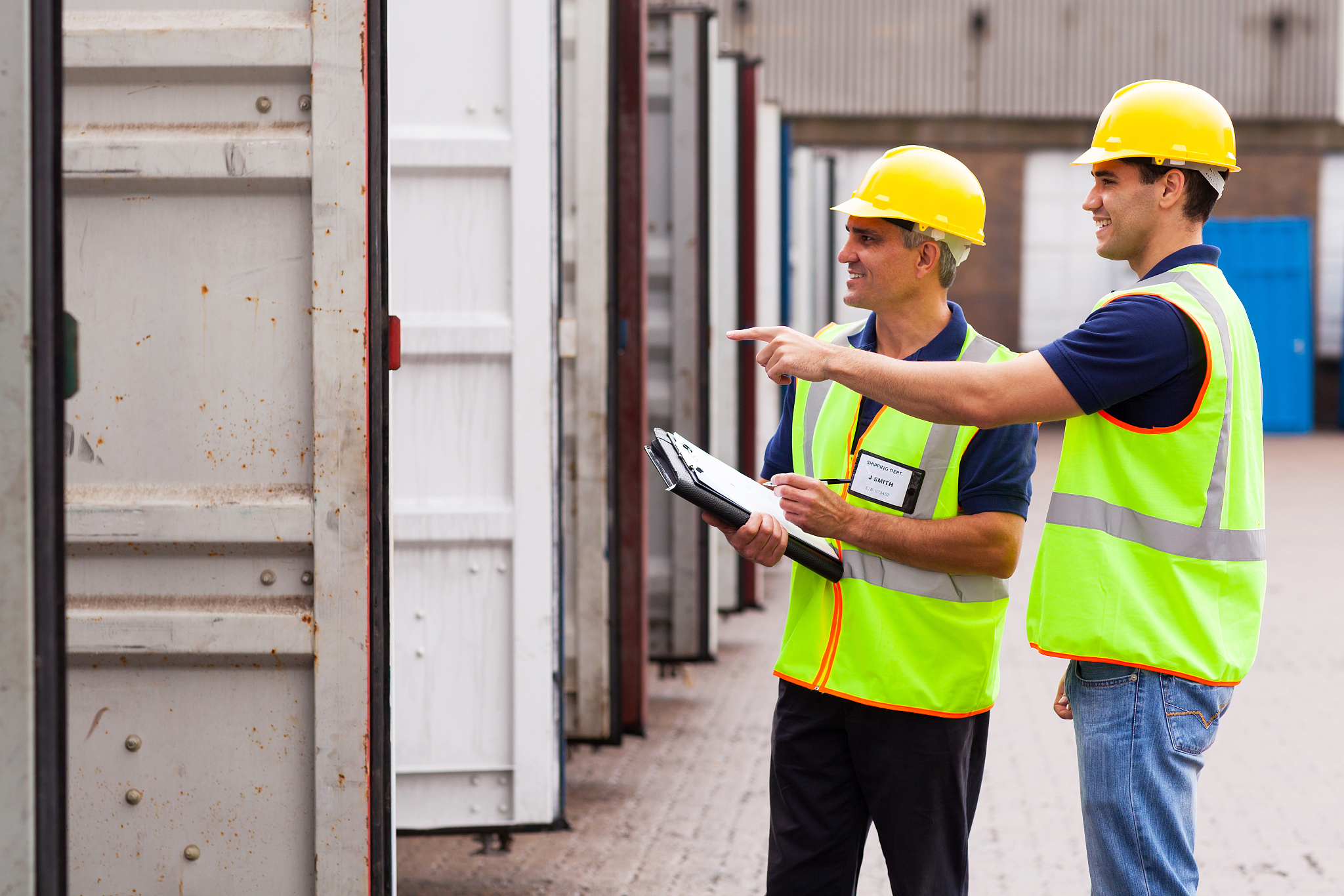 warehouse workers checking open containers