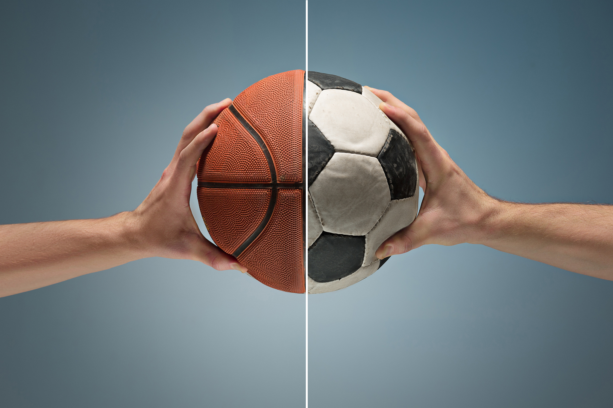 hands holding soccer ball
