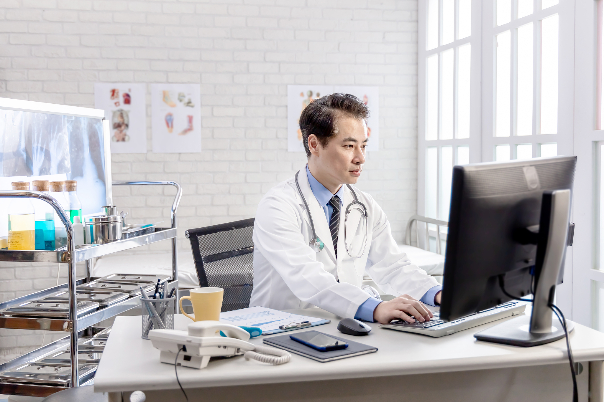 asian senior doctor use computer
