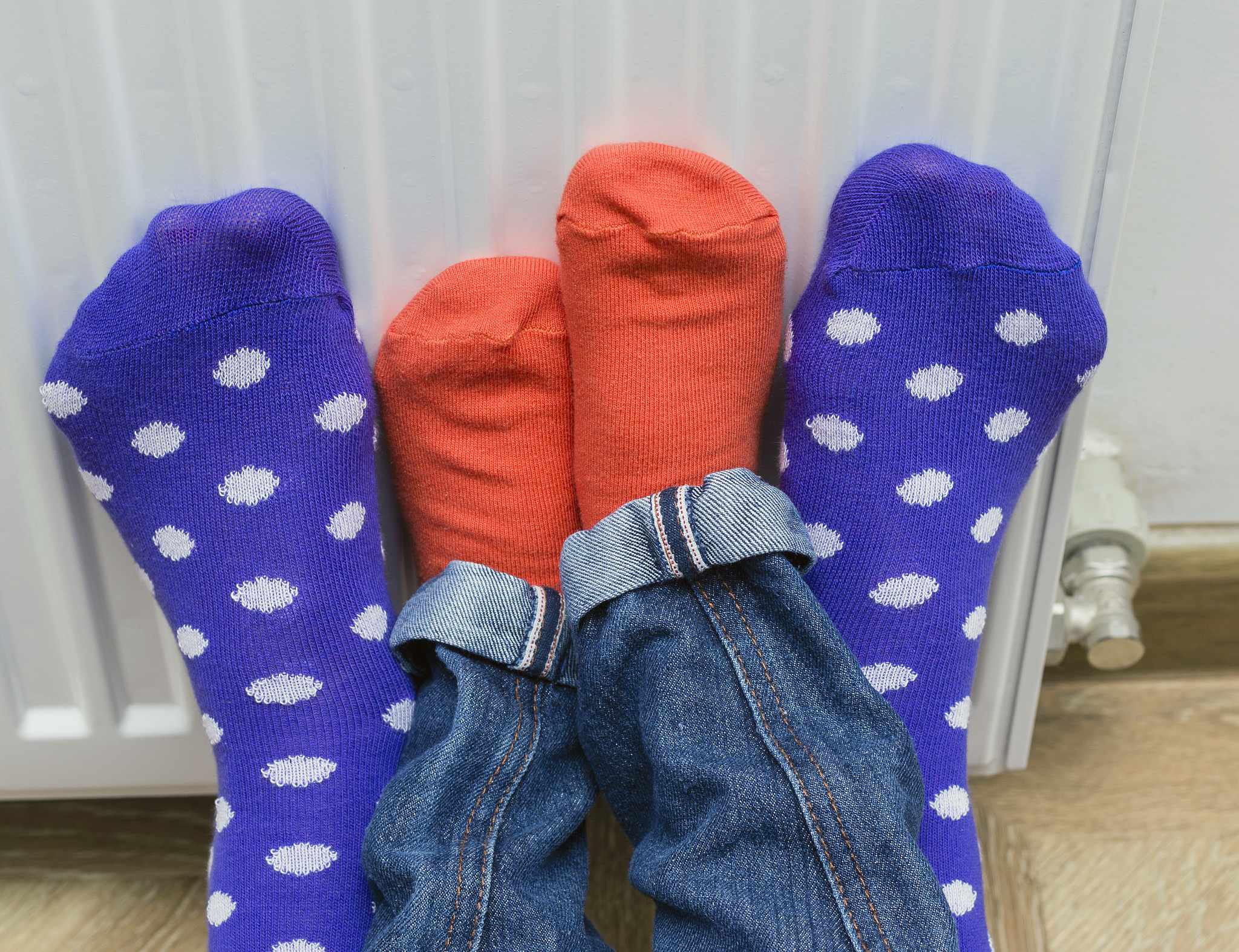 woman and child wearing colorful pair of socks warming cold feet